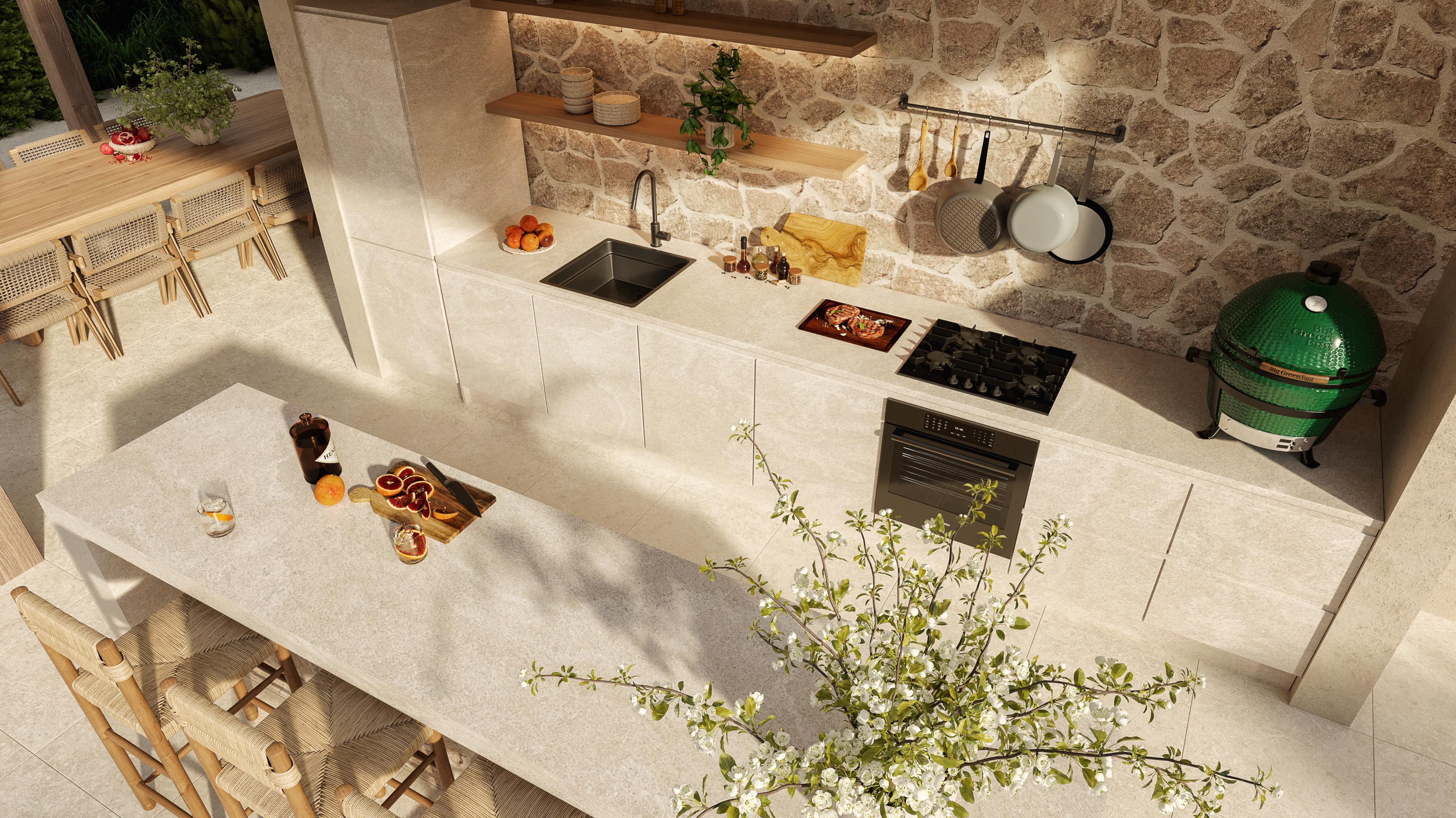 Outdoor kitchen counter with a stone wall, a barbecue and fresh produce
