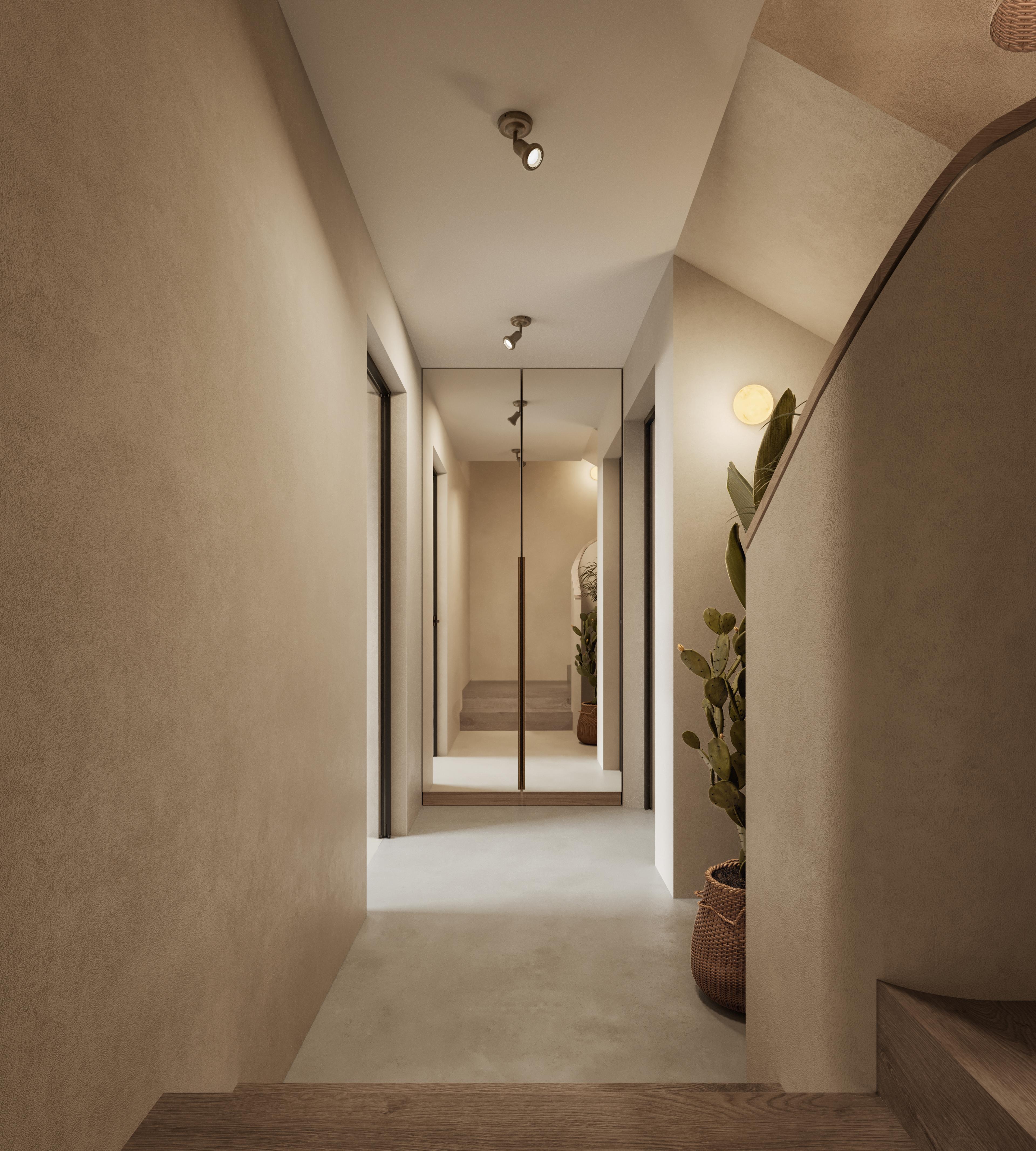 Basement hallway with warm plaster walls, a staircase and a plant in the corner