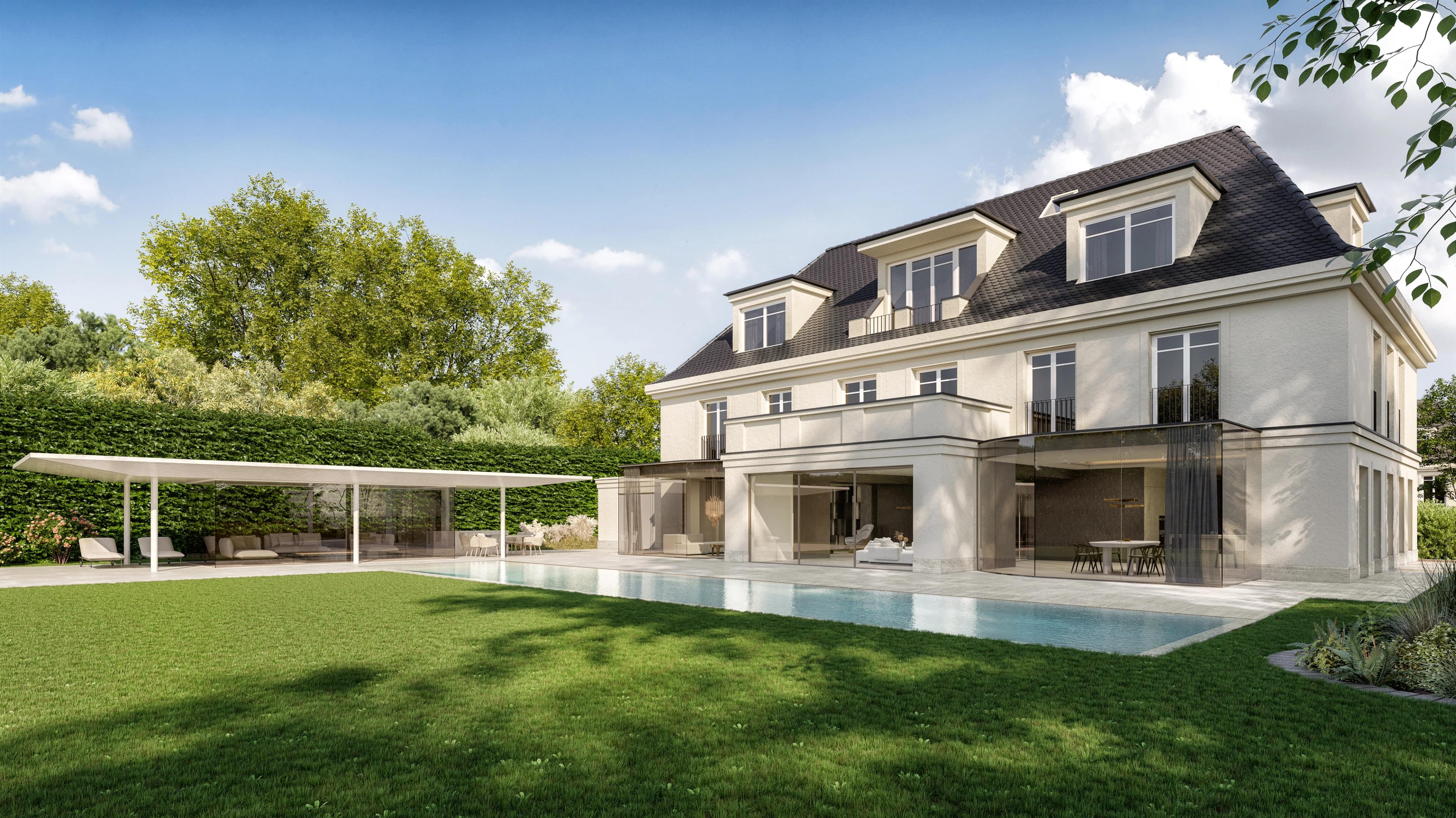 Rear facade of a pale stone villa with dormer windows, a pool and a glass-walled terrace pavilion