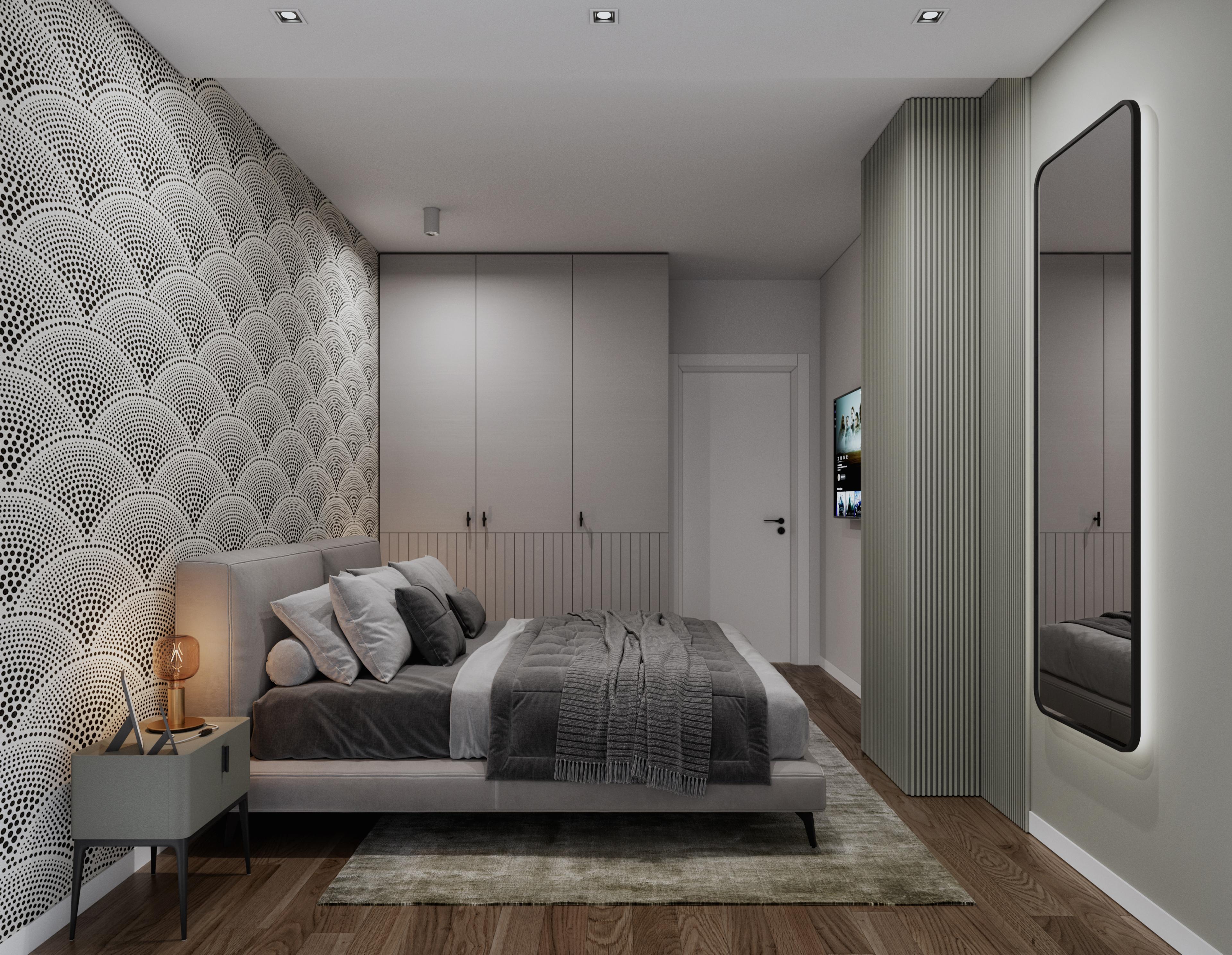 Bedroom with a scalloped patterned feature wall, a grey upholstered bed and a tall mirror