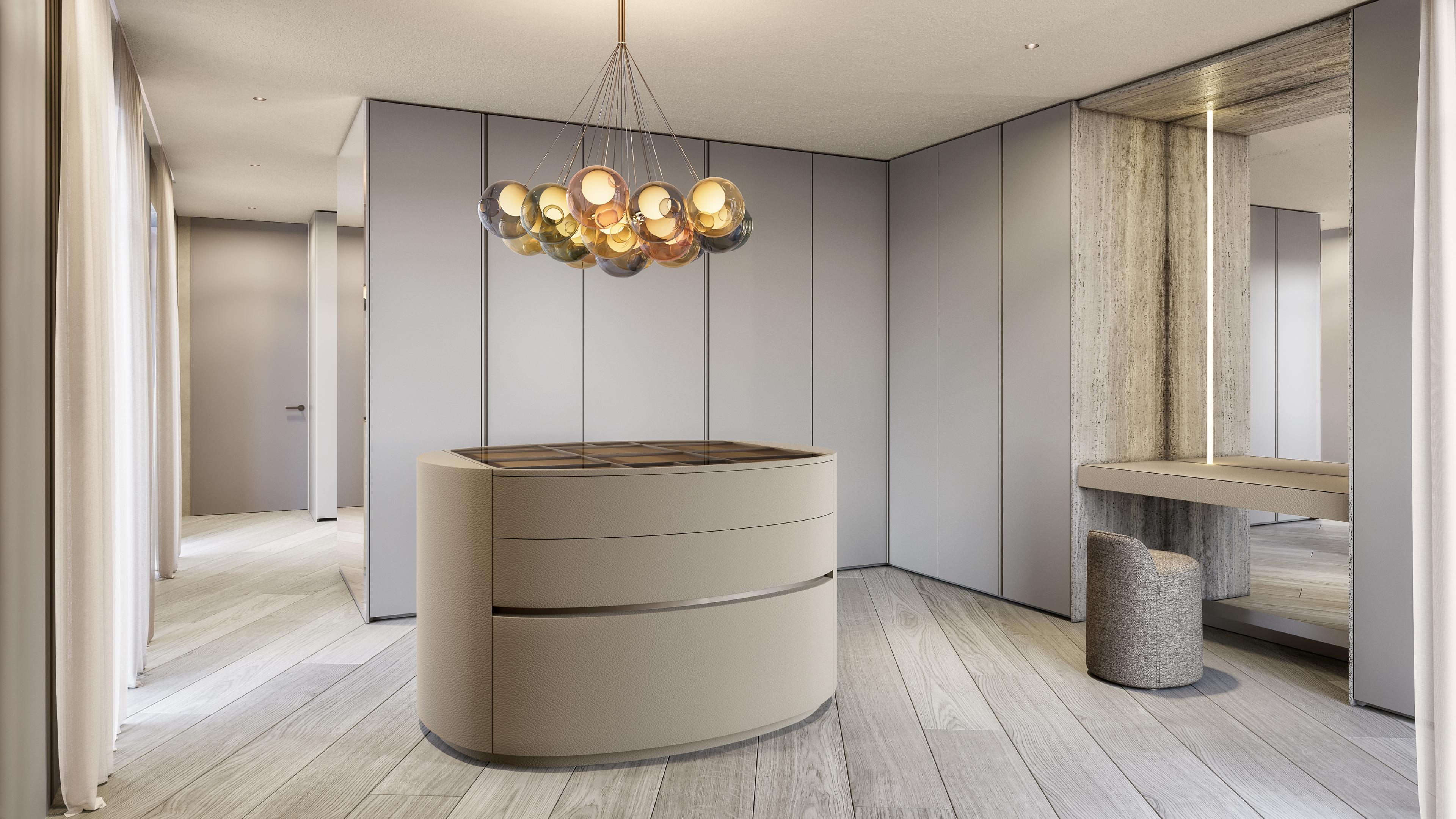 Dressing room with a round central island, a bubble chandelier and a vanity with mirror