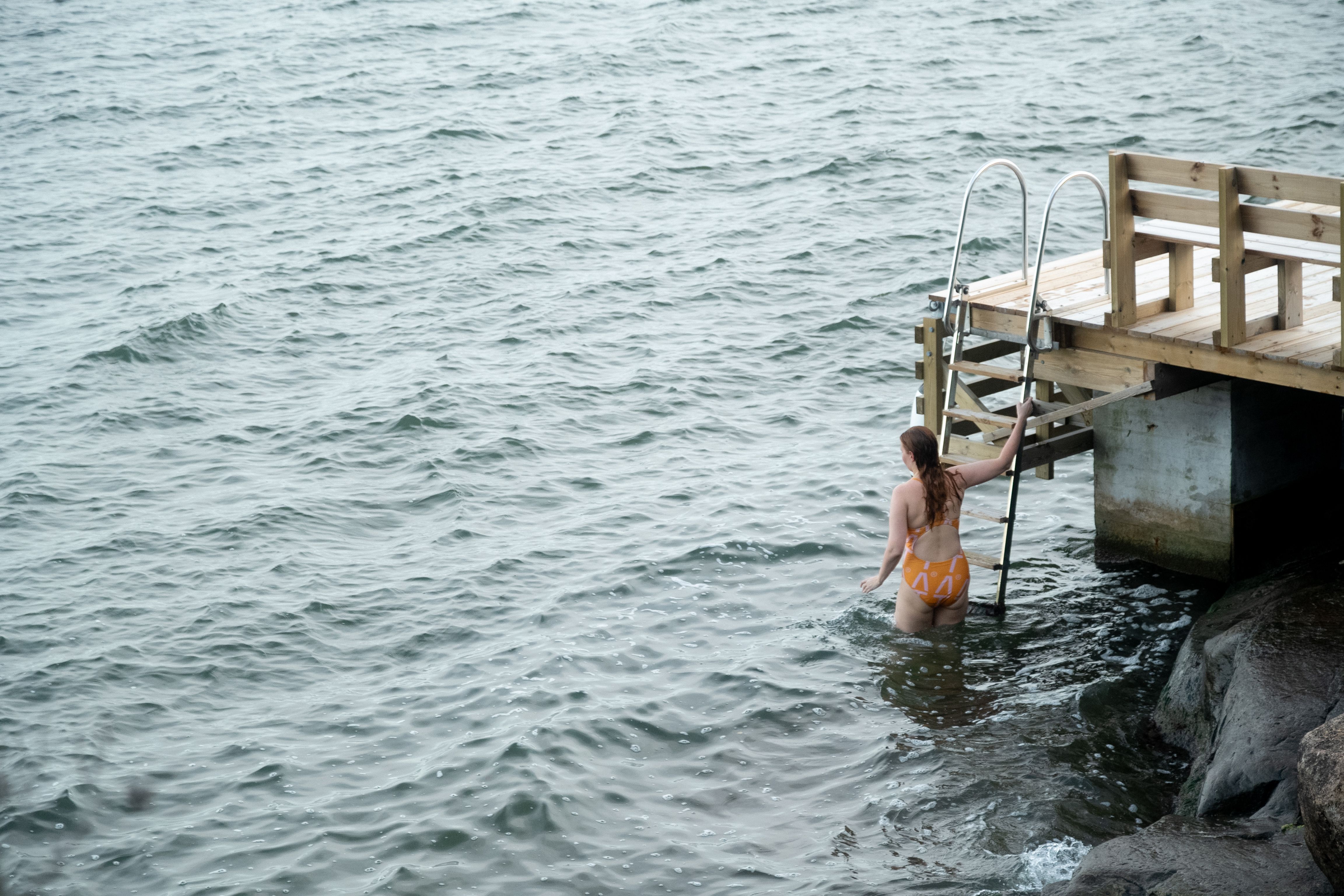 A woman descending into the water