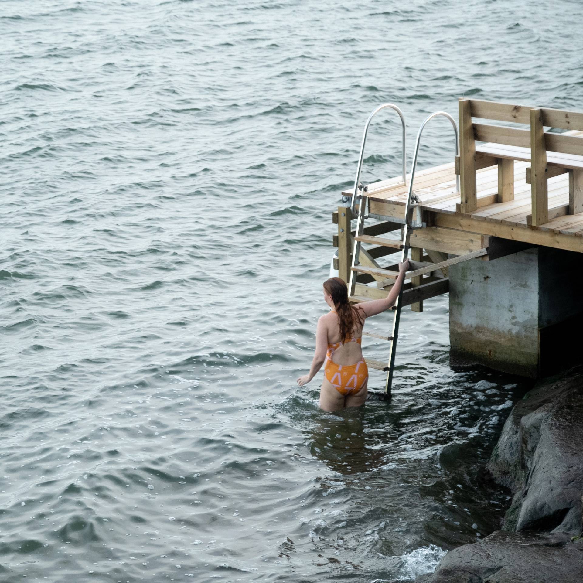 A woman descending into the water