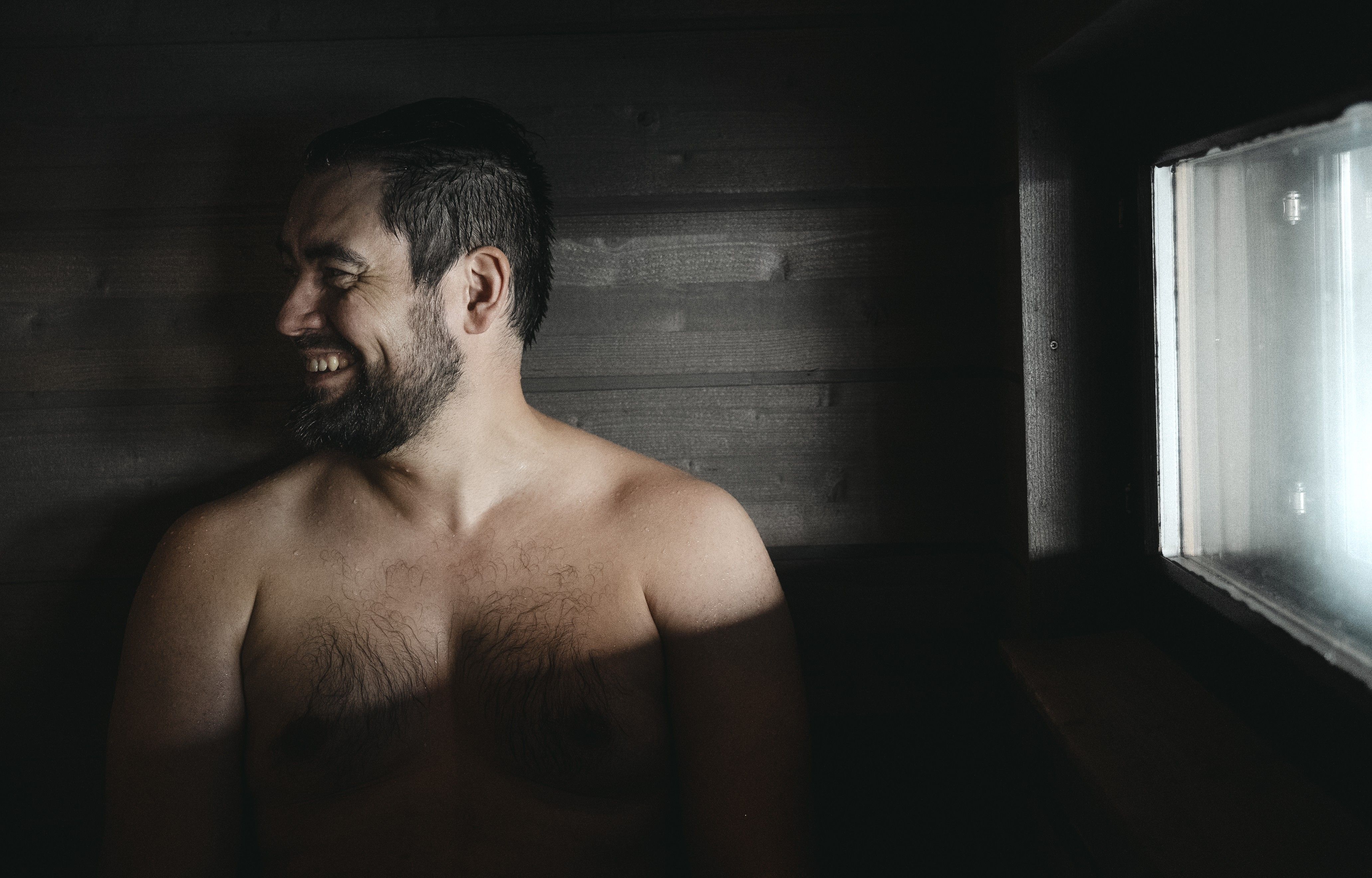 A Finnish man in a sauna. At archipelago of Finland.