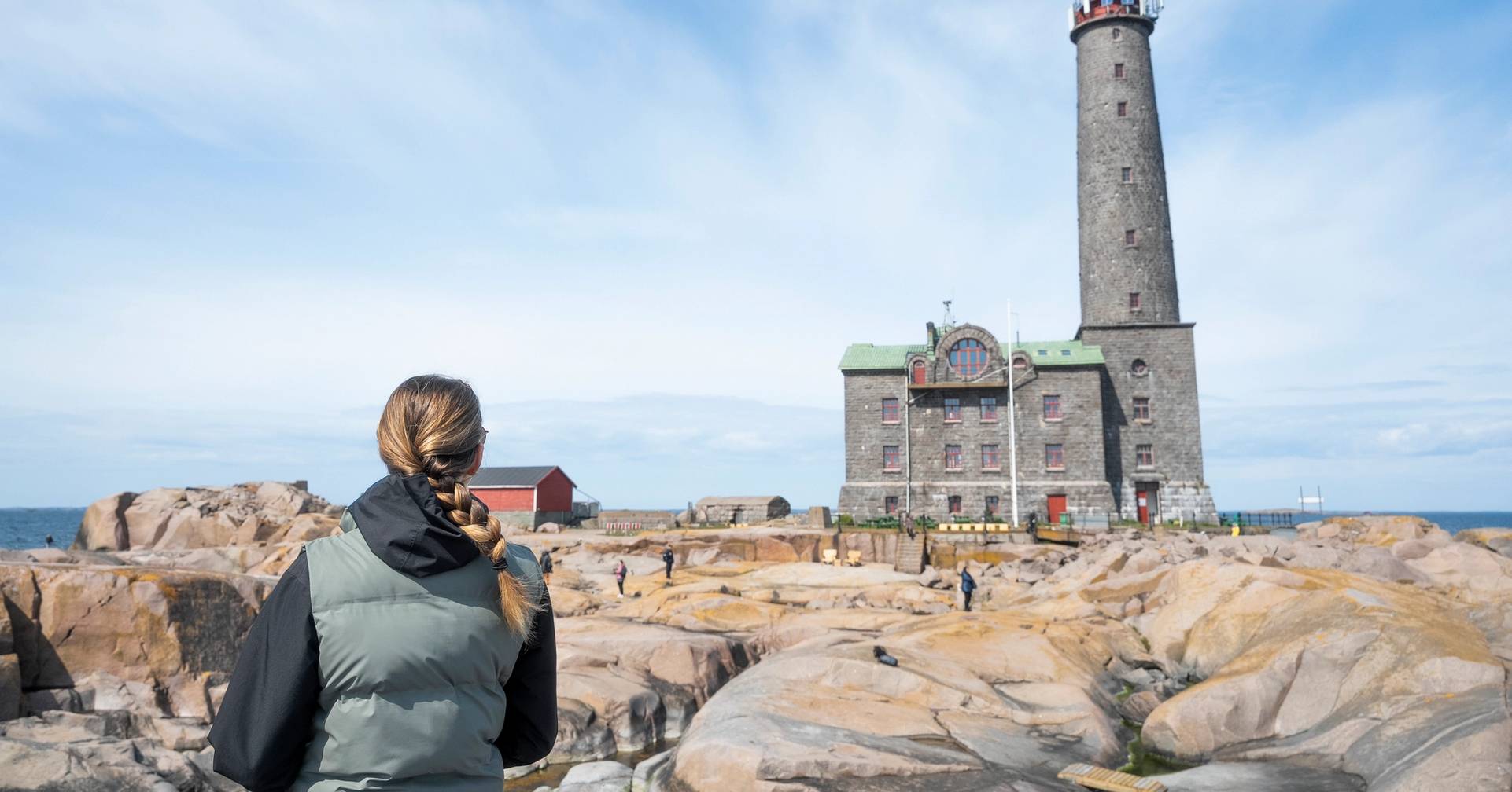 A person admiring the Bengtskär lighthouse.