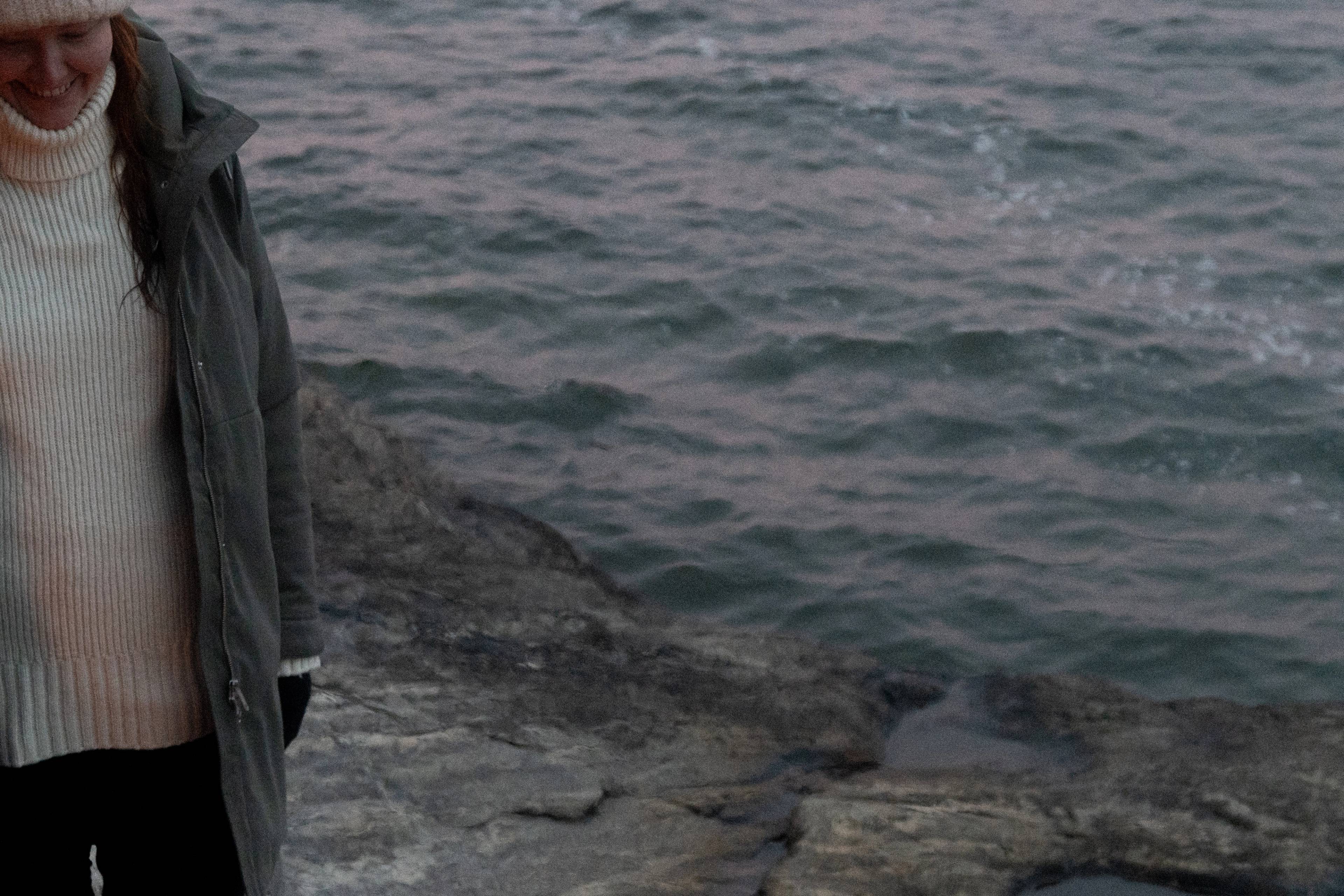 A person standing by the sea shore.