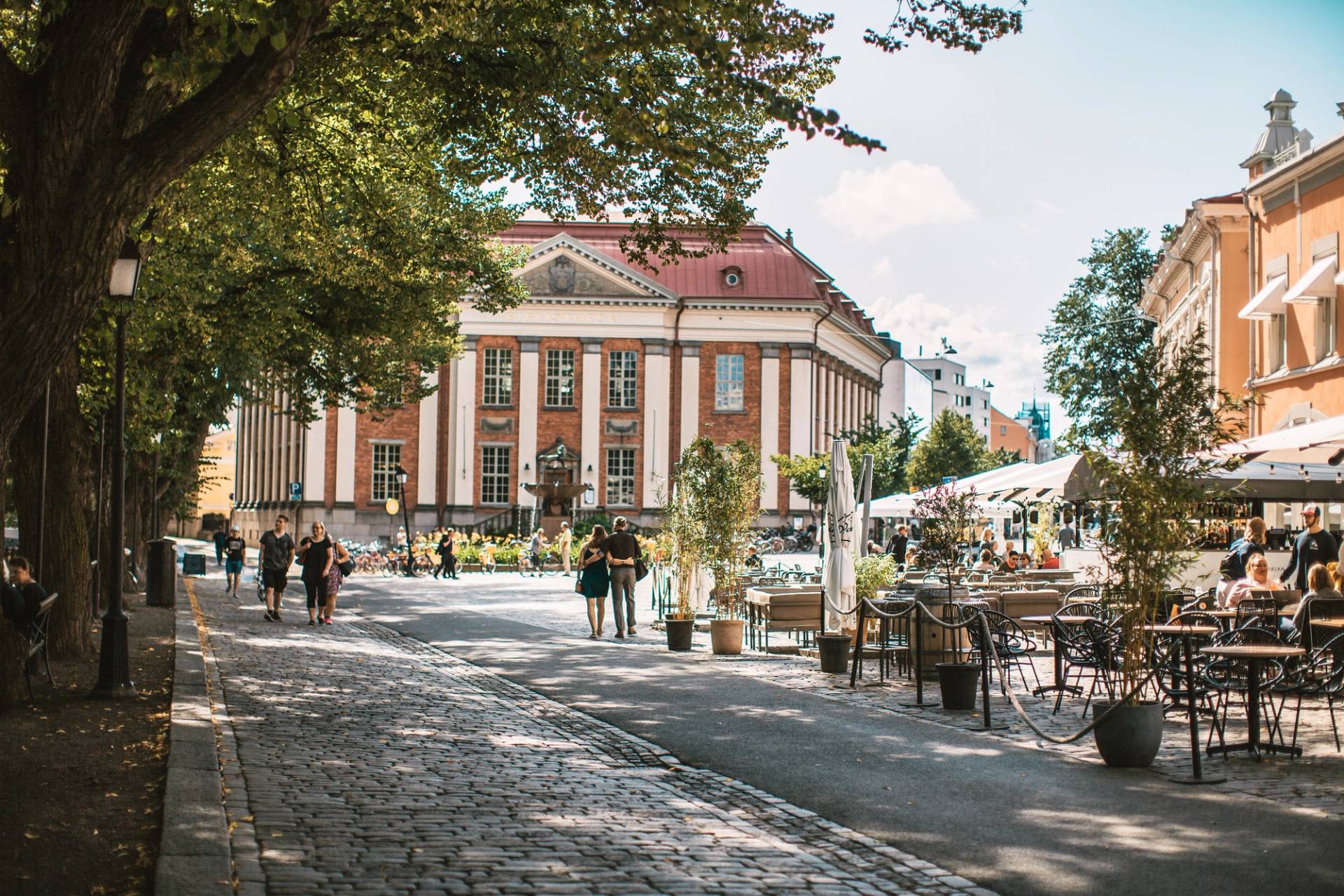A summer view from an old Finnish town with street cafés and people wandering about