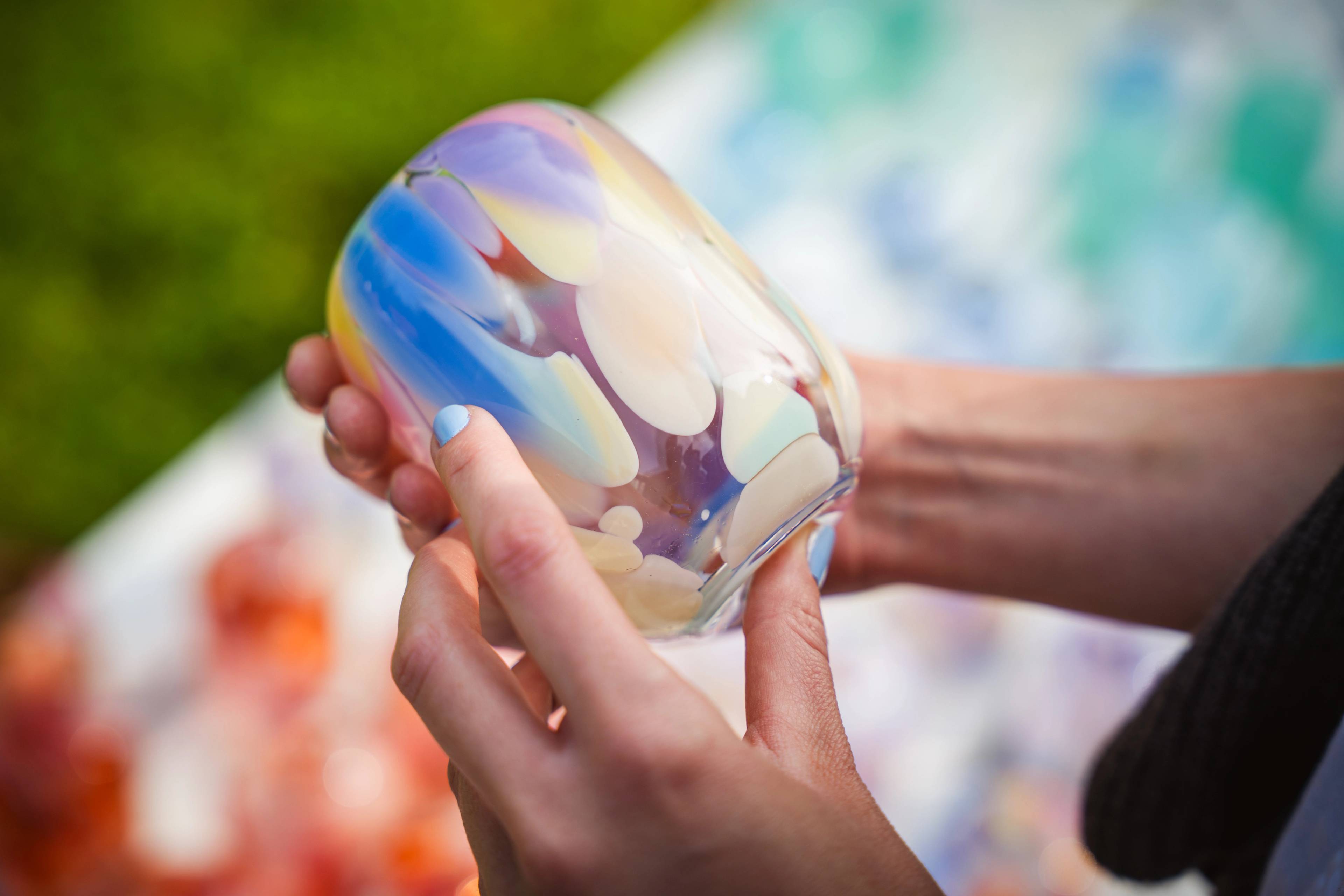 A person holding a glass cup.