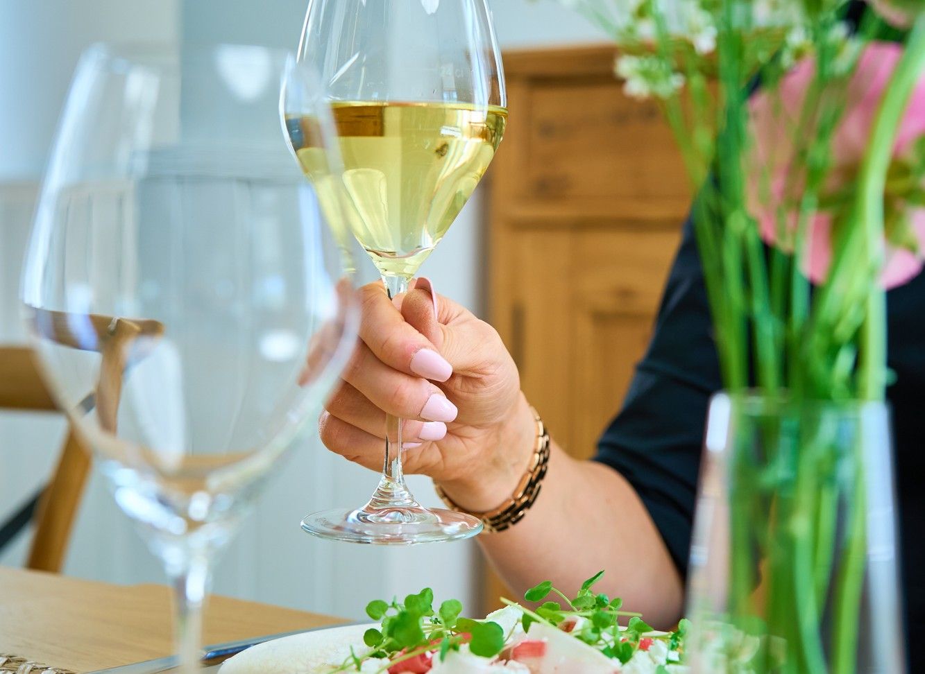 A wine glass and person dining