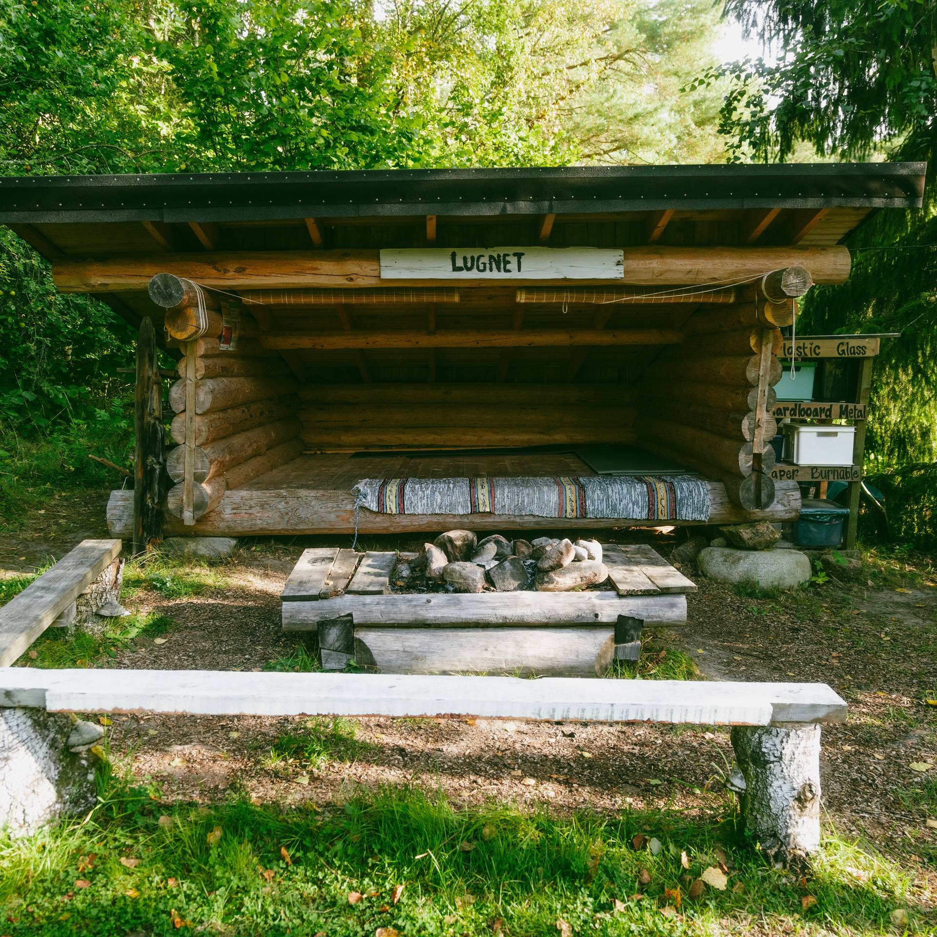 An outdoor hut in the woods.
