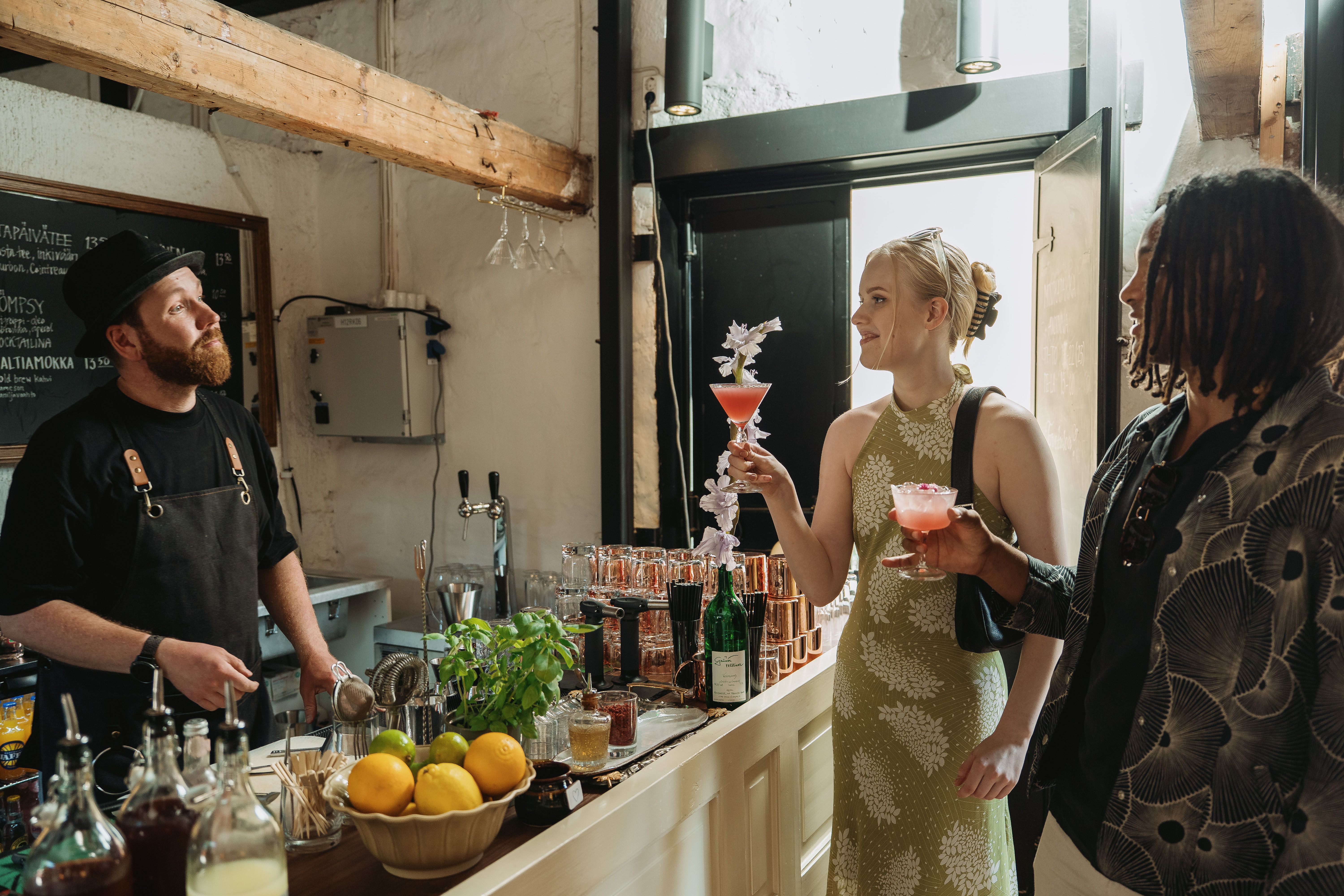 Two people holding cocktails.