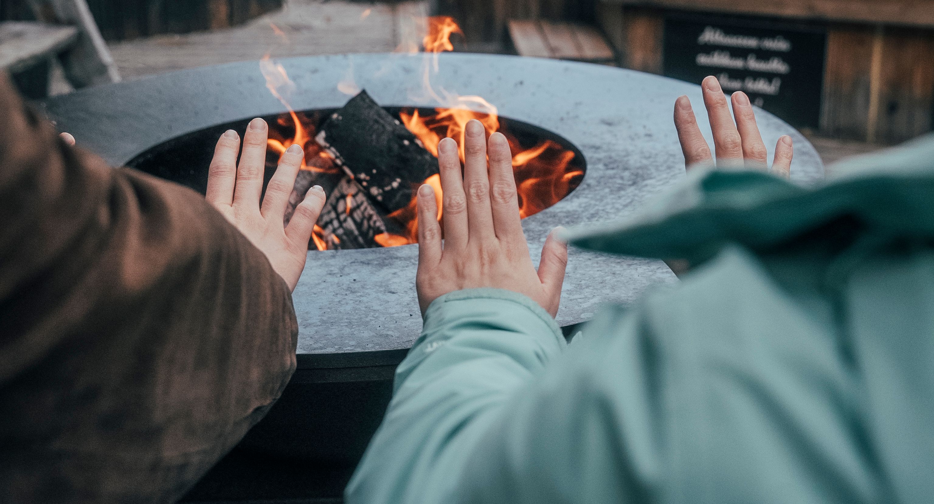People warming their hands by a fire.