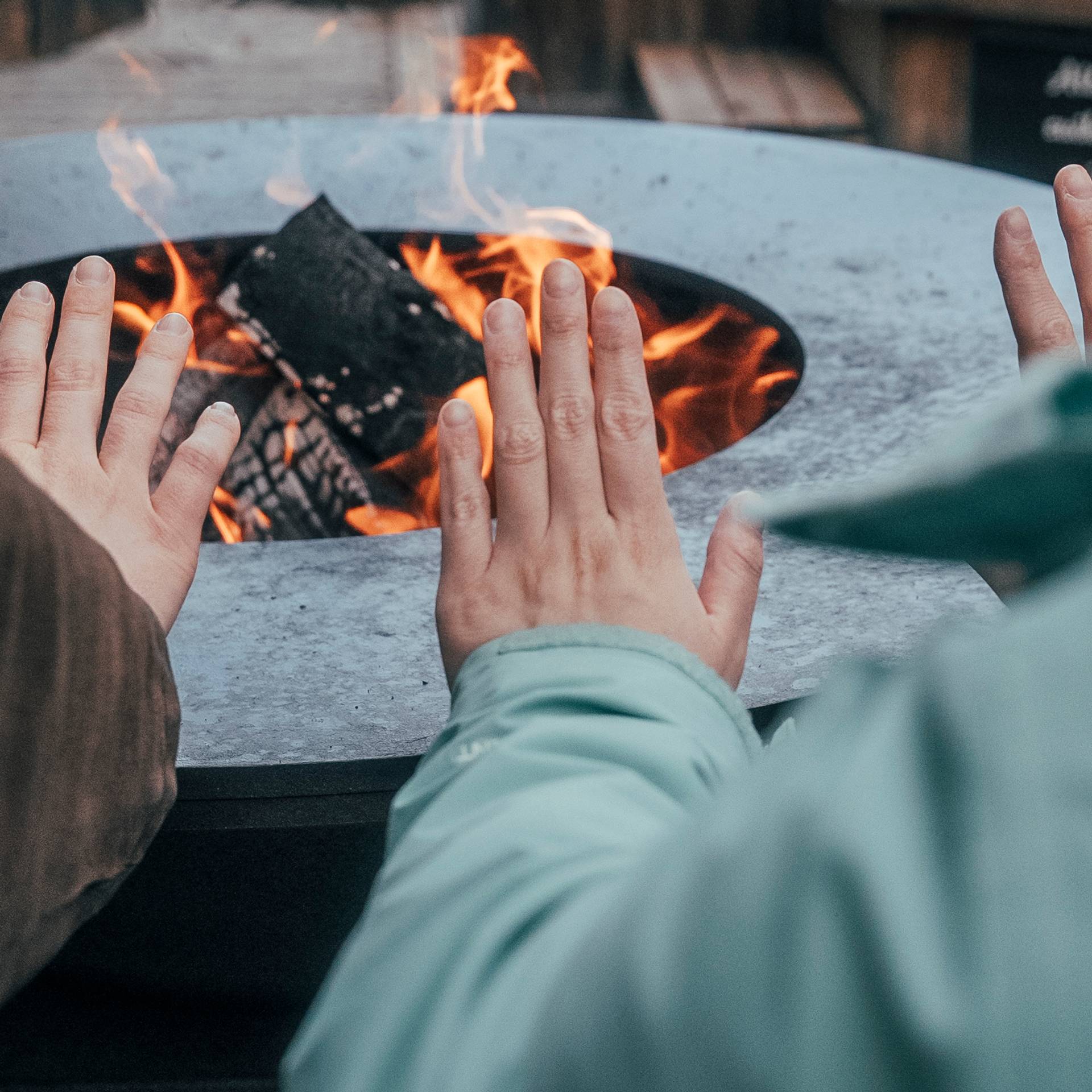 People warming their hands by a fire.