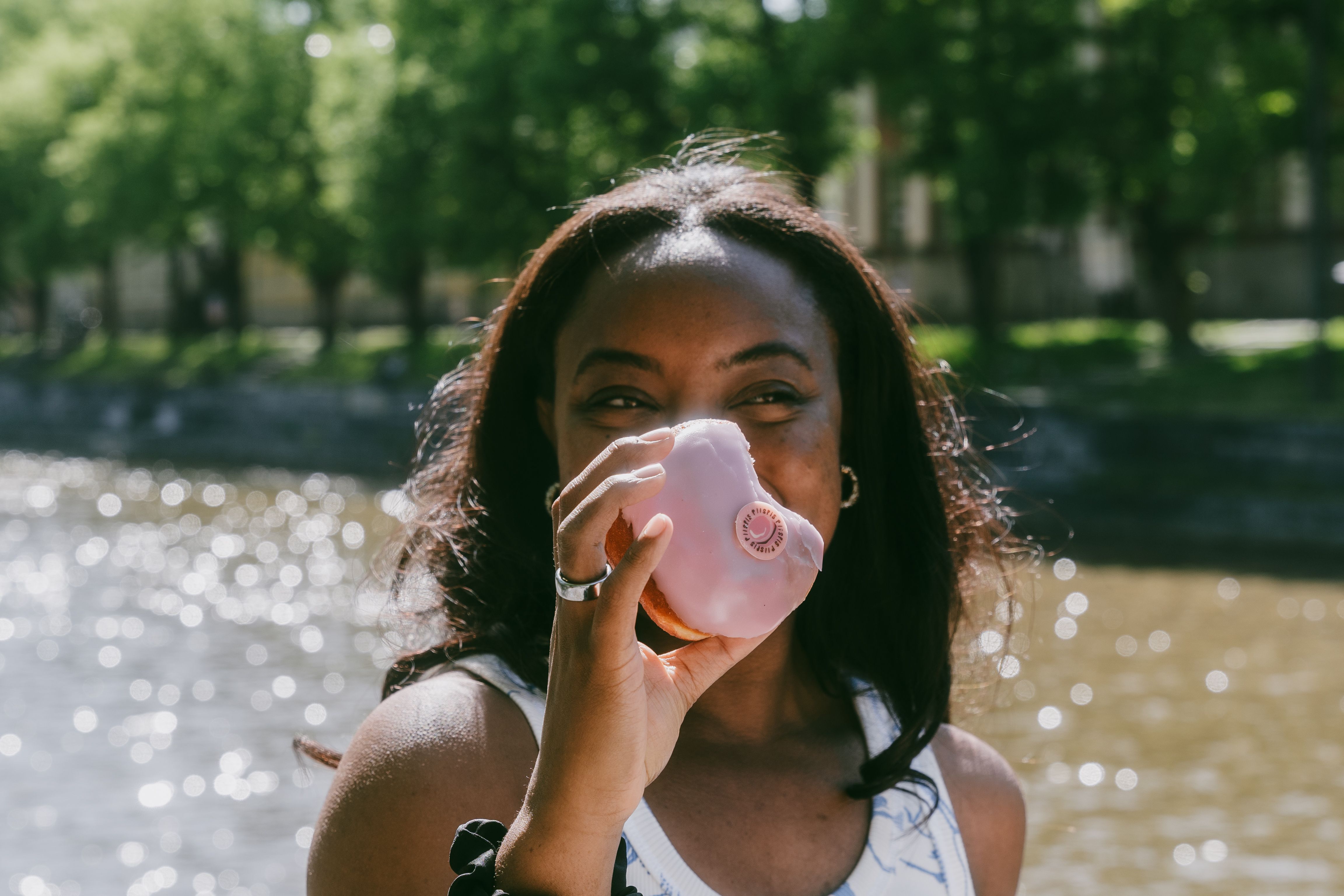 A person holding a Turku donut or piispanmunkki.