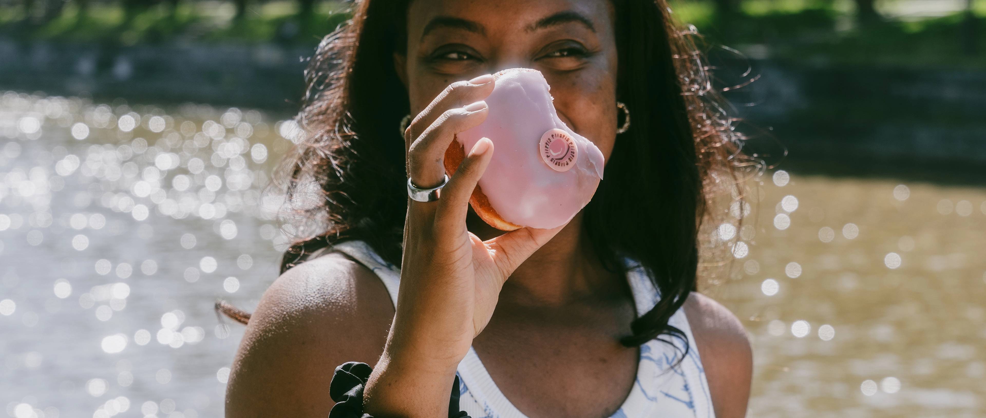 A person holding a Turku donut or piispanmunkki.