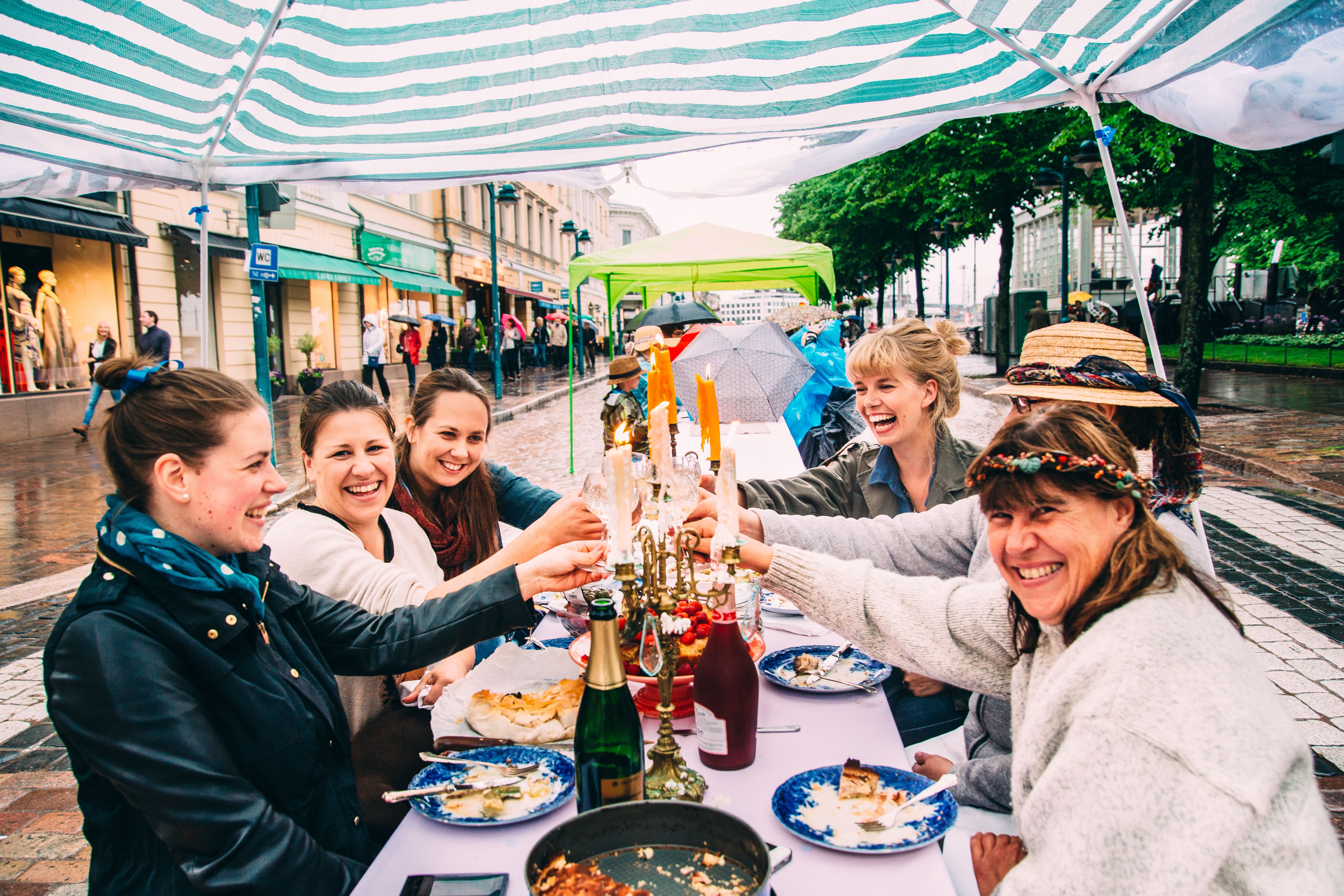 People eating and laughing in Helsinki.
