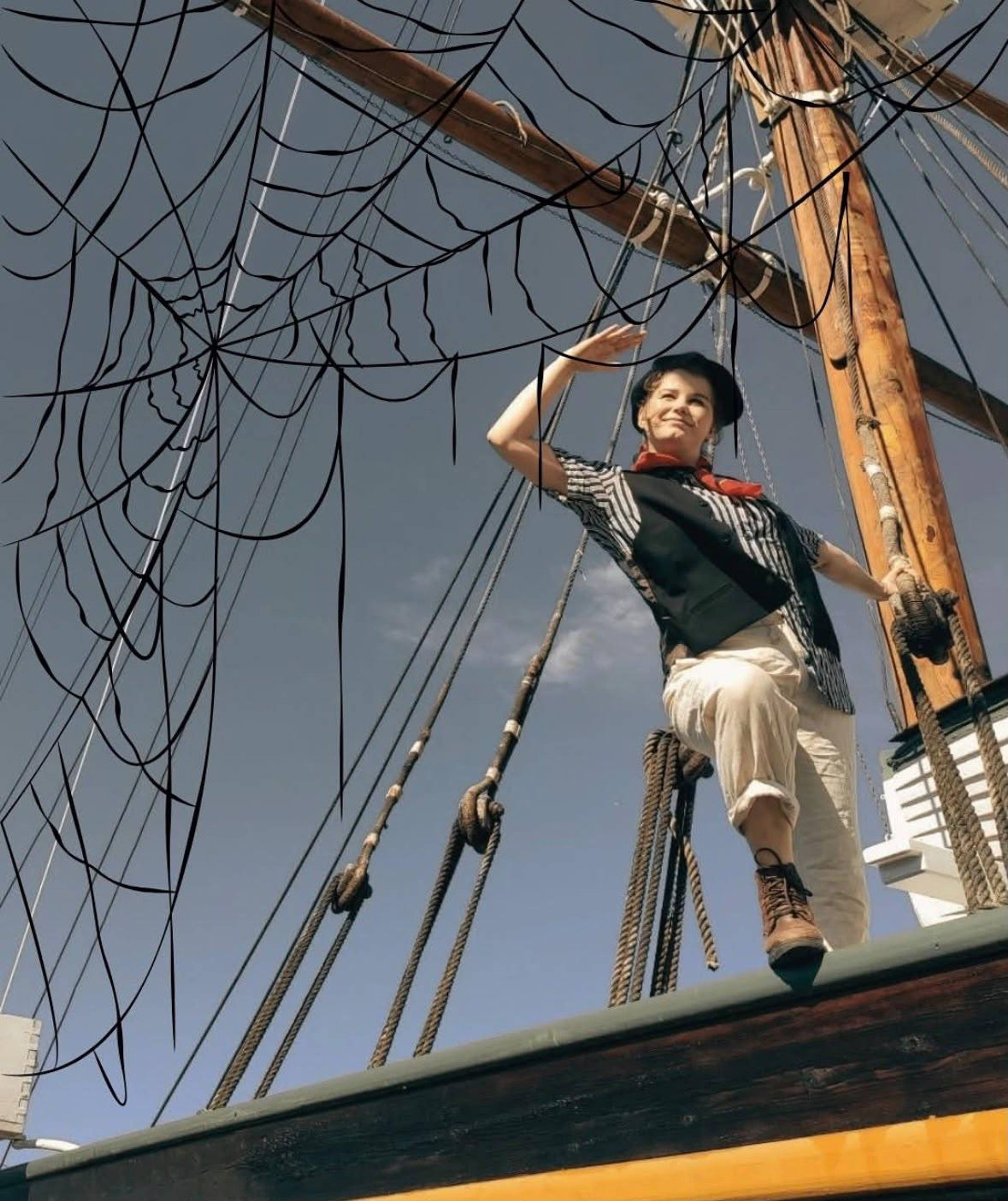 A person looking toward the horizon from an old wooden boat.