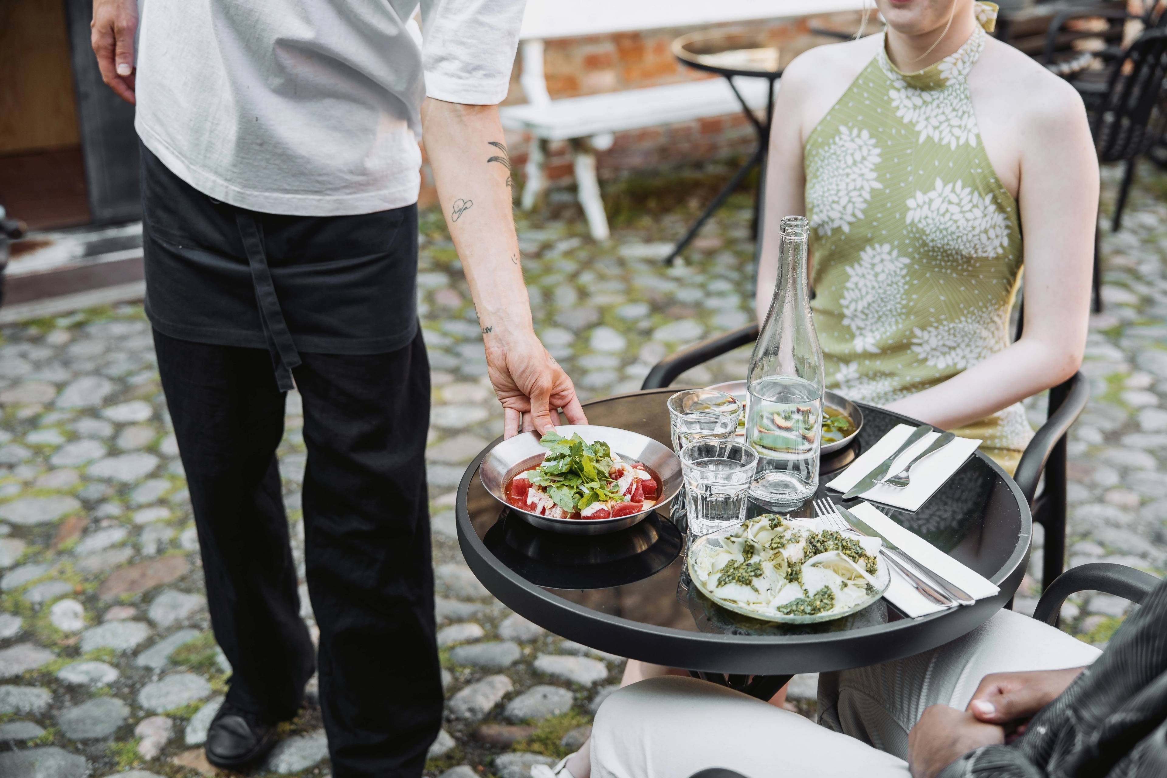 Two people being served food.