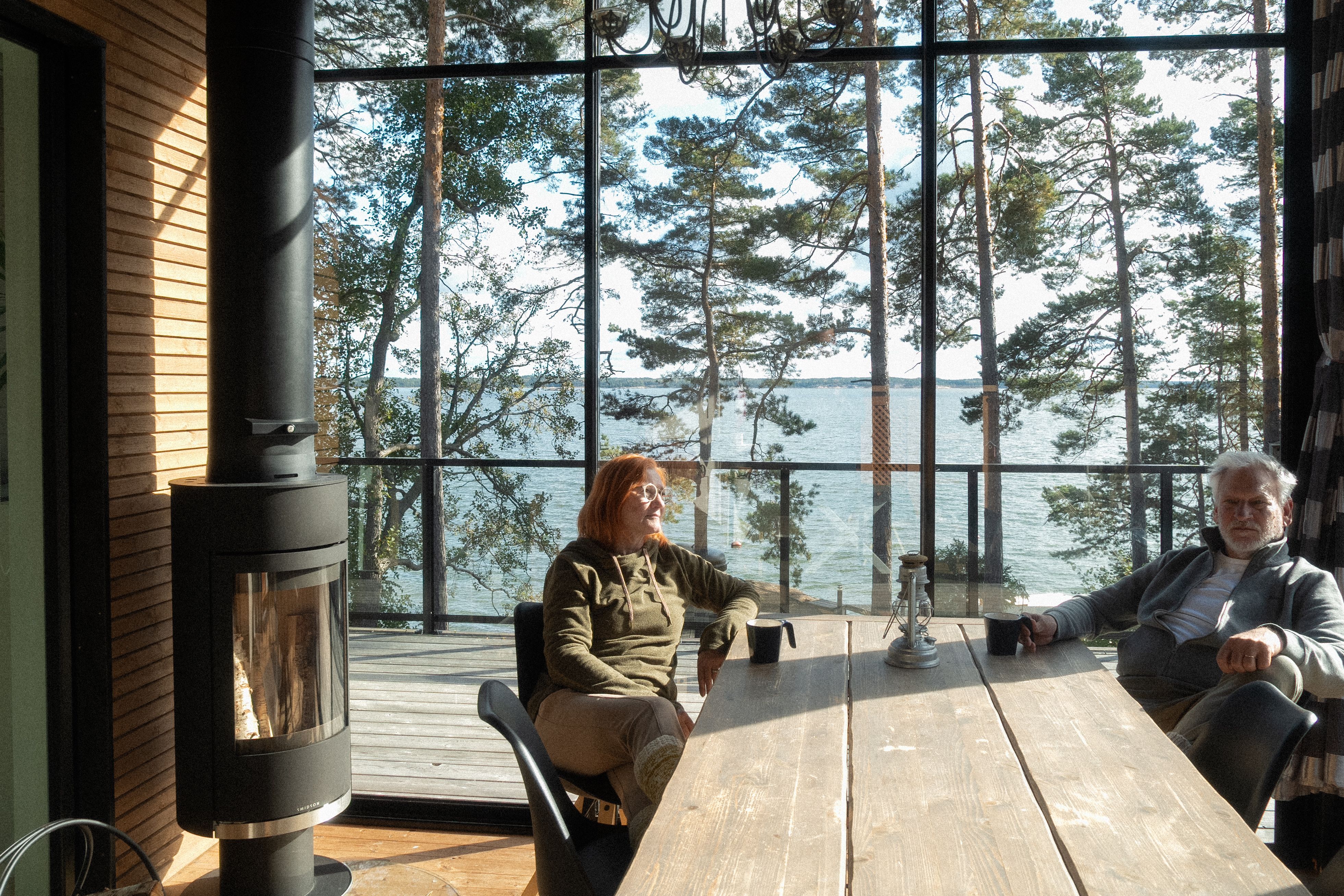 Two people sitting around a table in a cabin.