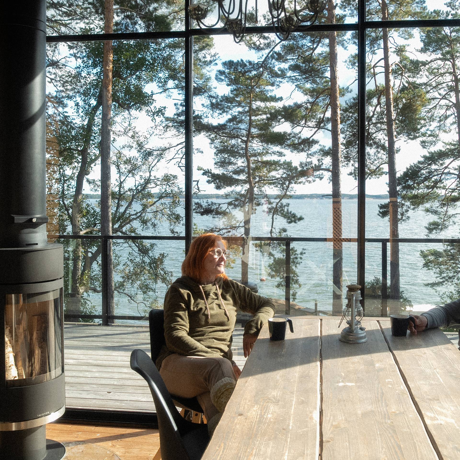 Two people sitting around a table in a cabin.