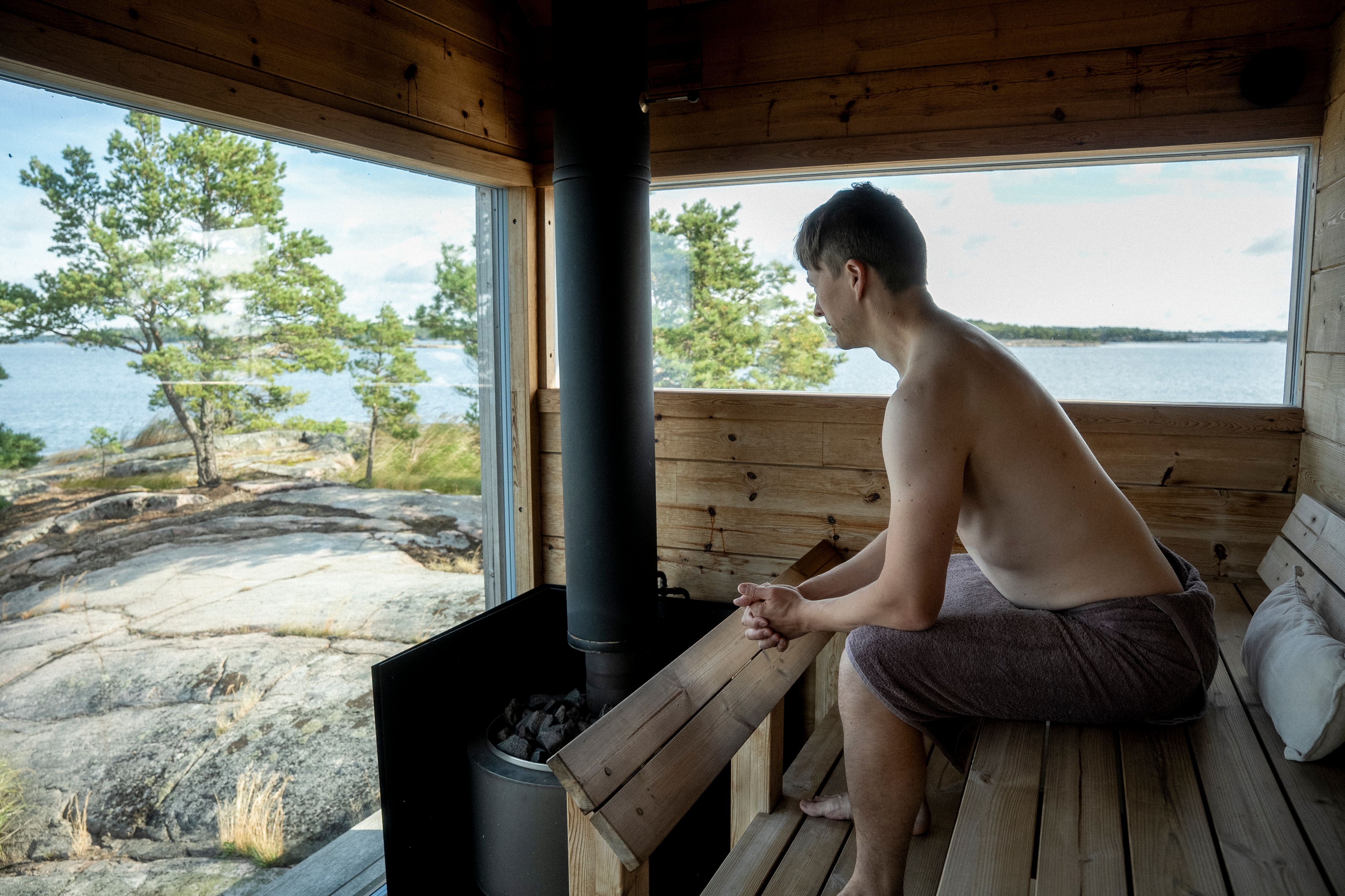 A person sitting inside a sauna.