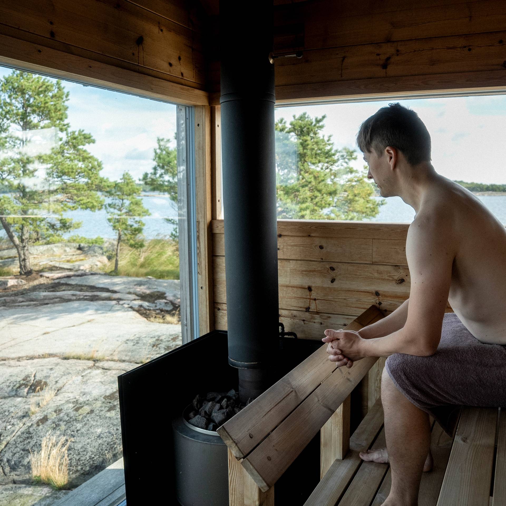 A person sitting inside a sauna.