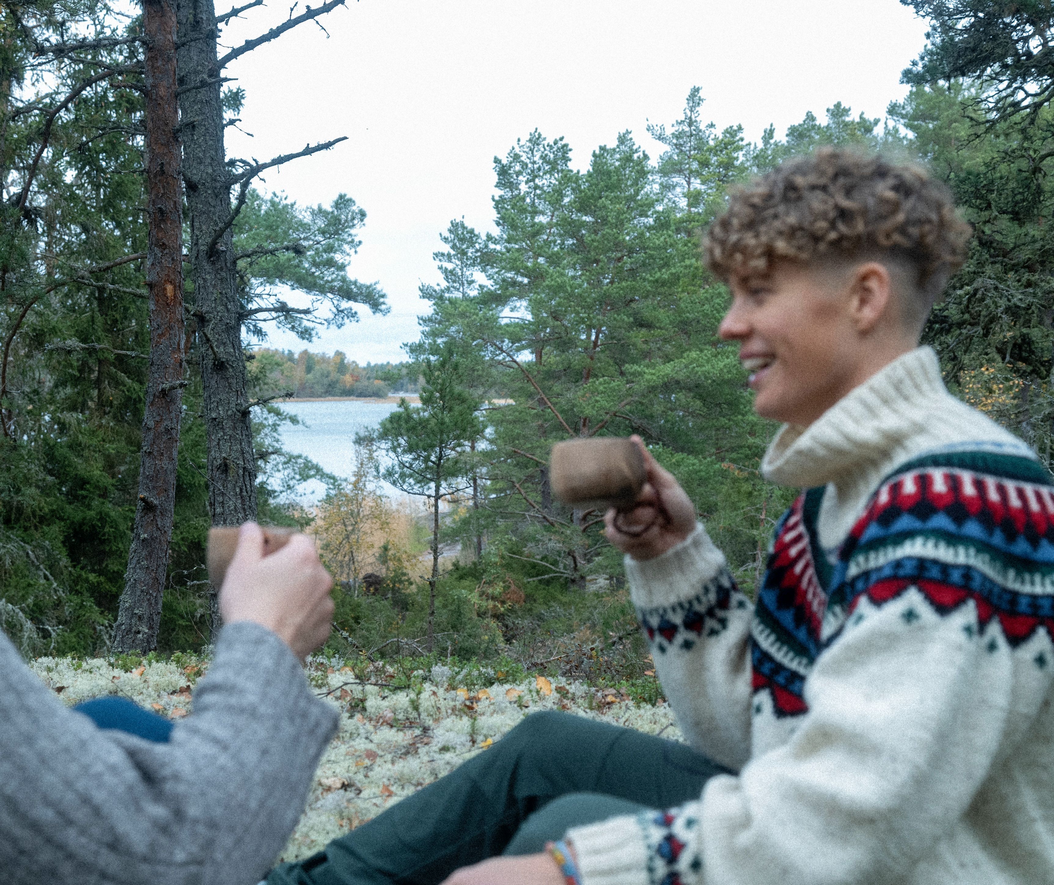 A woman drinking coffee in the forest