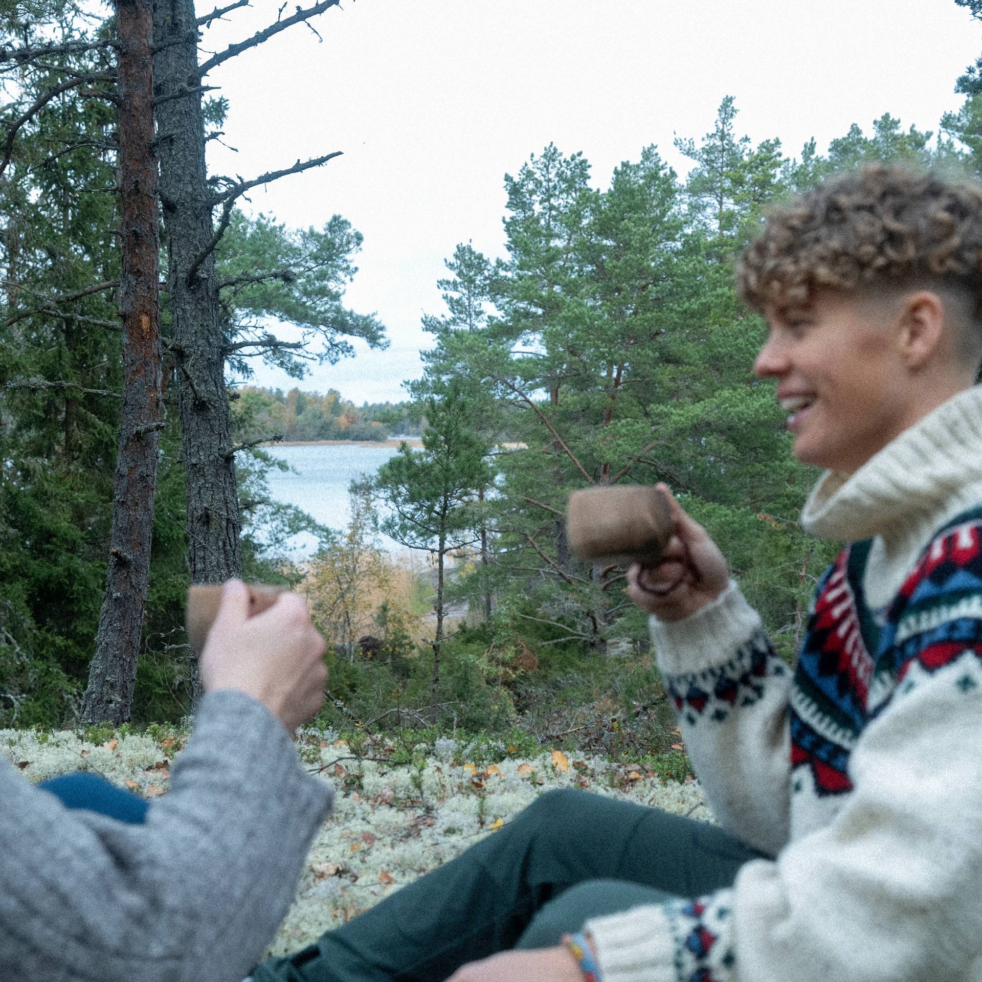 A woman drinking coffee in the forest