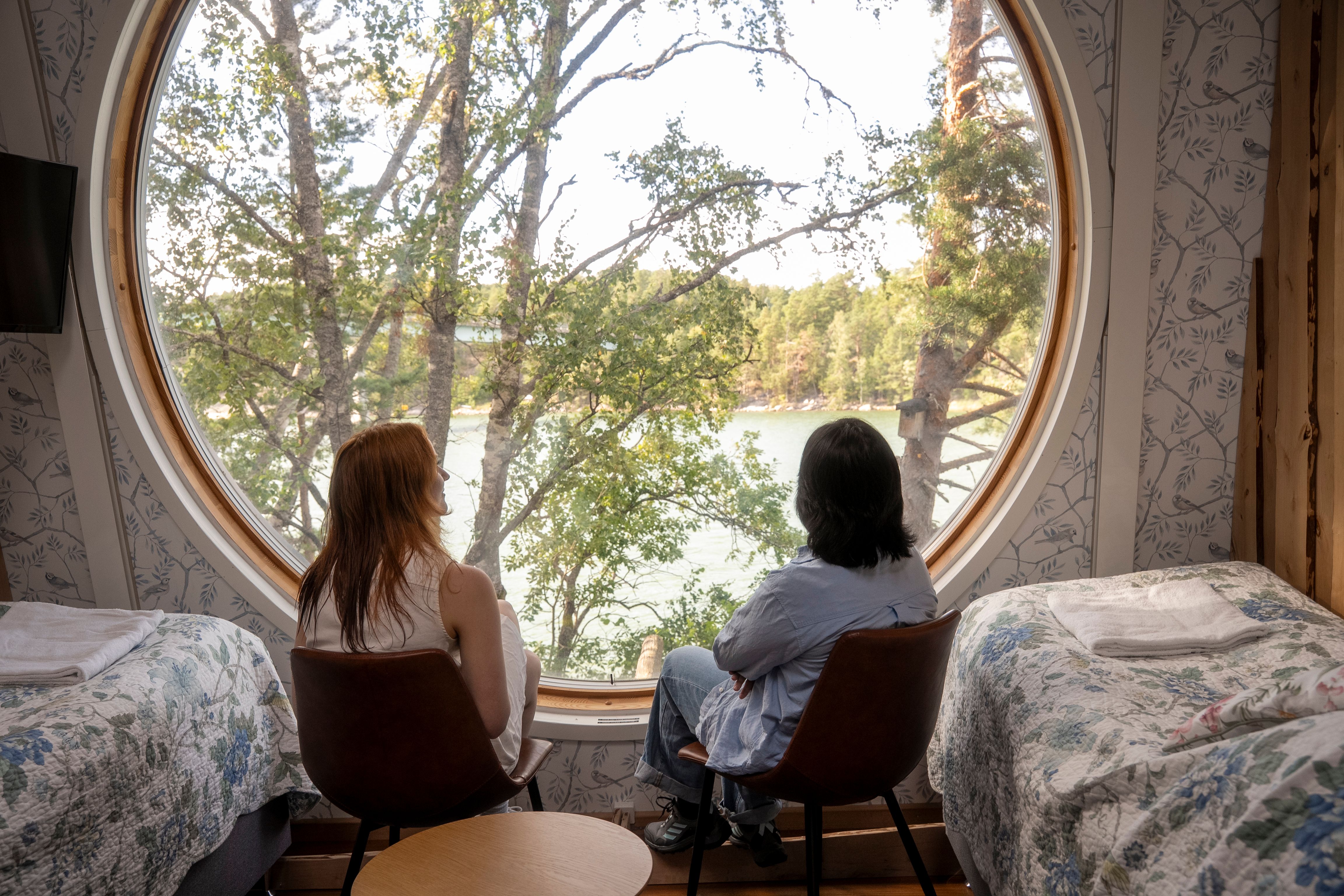 Two women enjoying a view in an archipelago cottage.