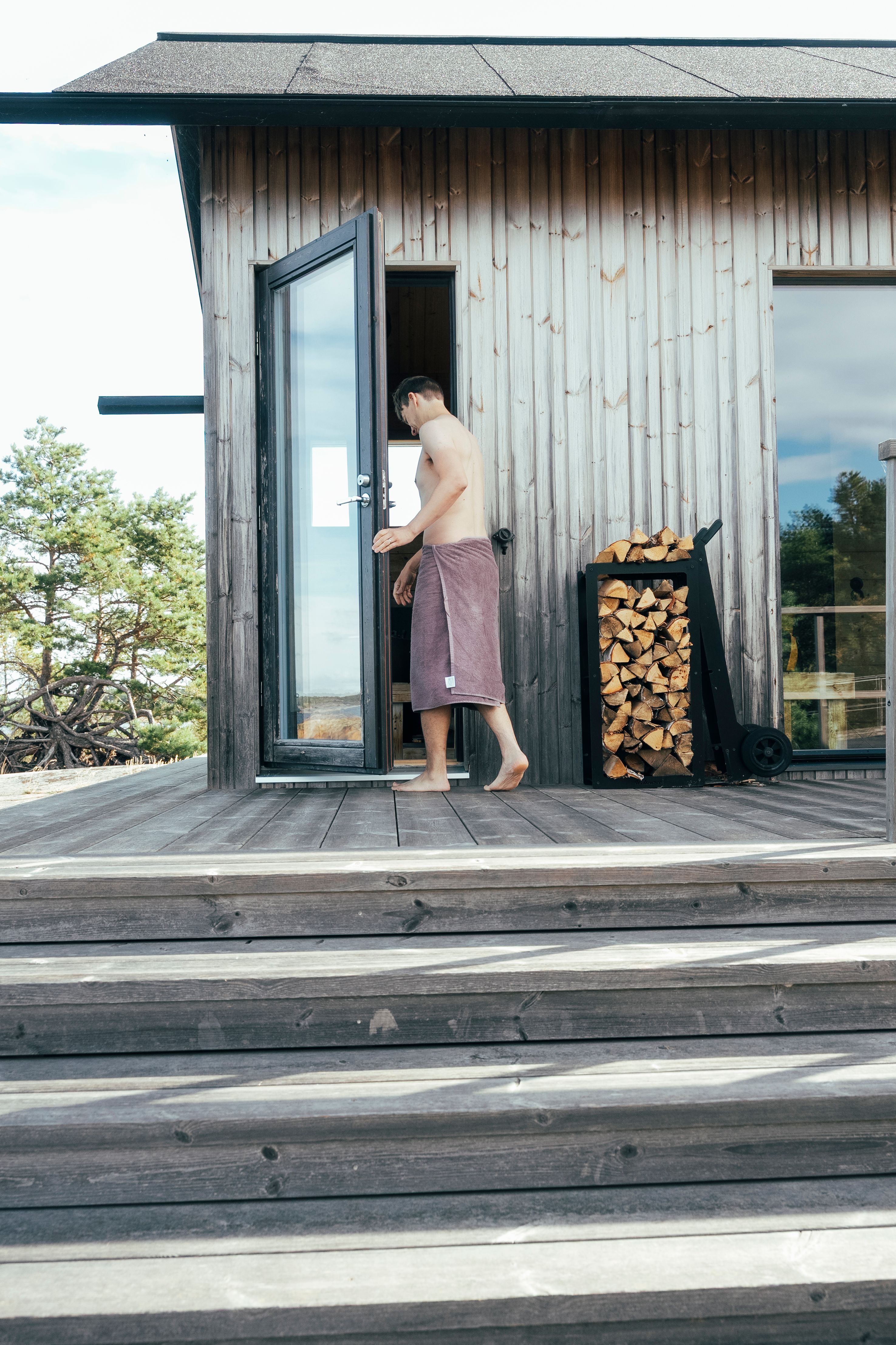 A person walking into a cabin sauna.