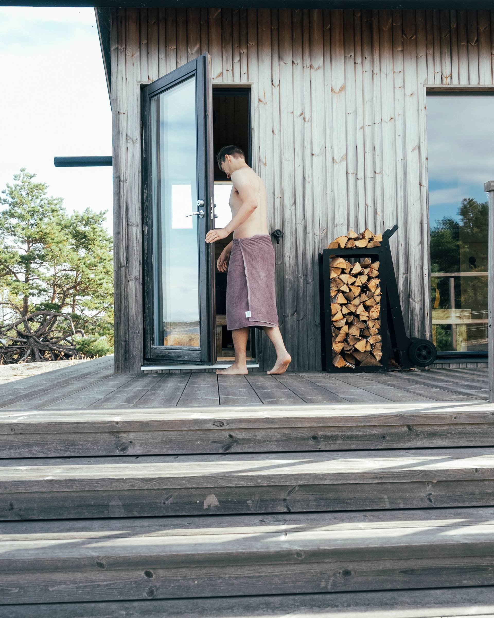 A person walking into a cabin sauna.