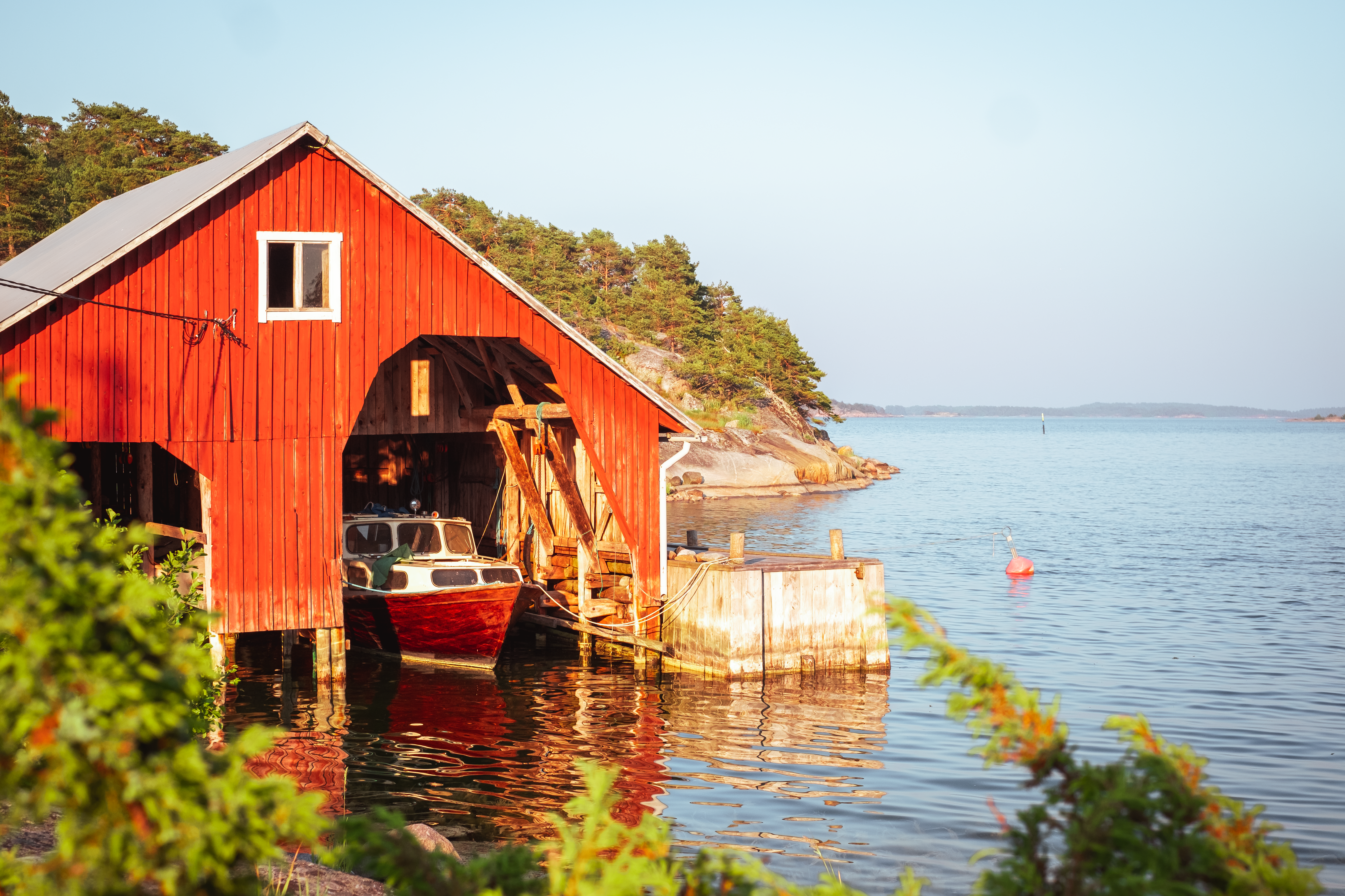 A red wooden boathouse in Brännskär island.