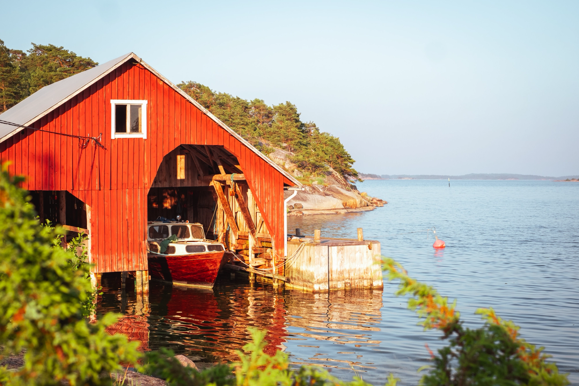 A red wooden boathouse in Brännskär island.