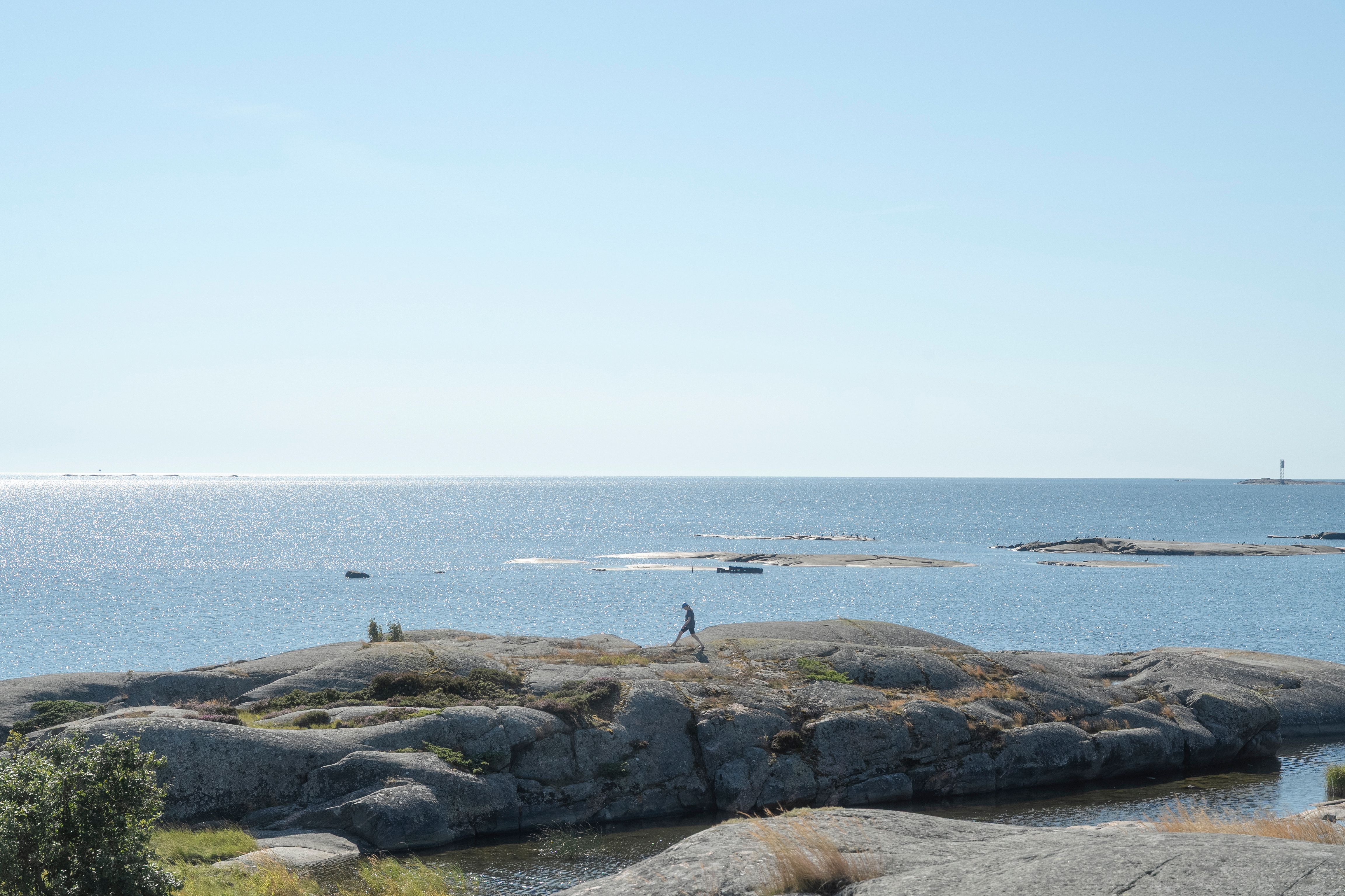 A person walking along the archipelago coast.