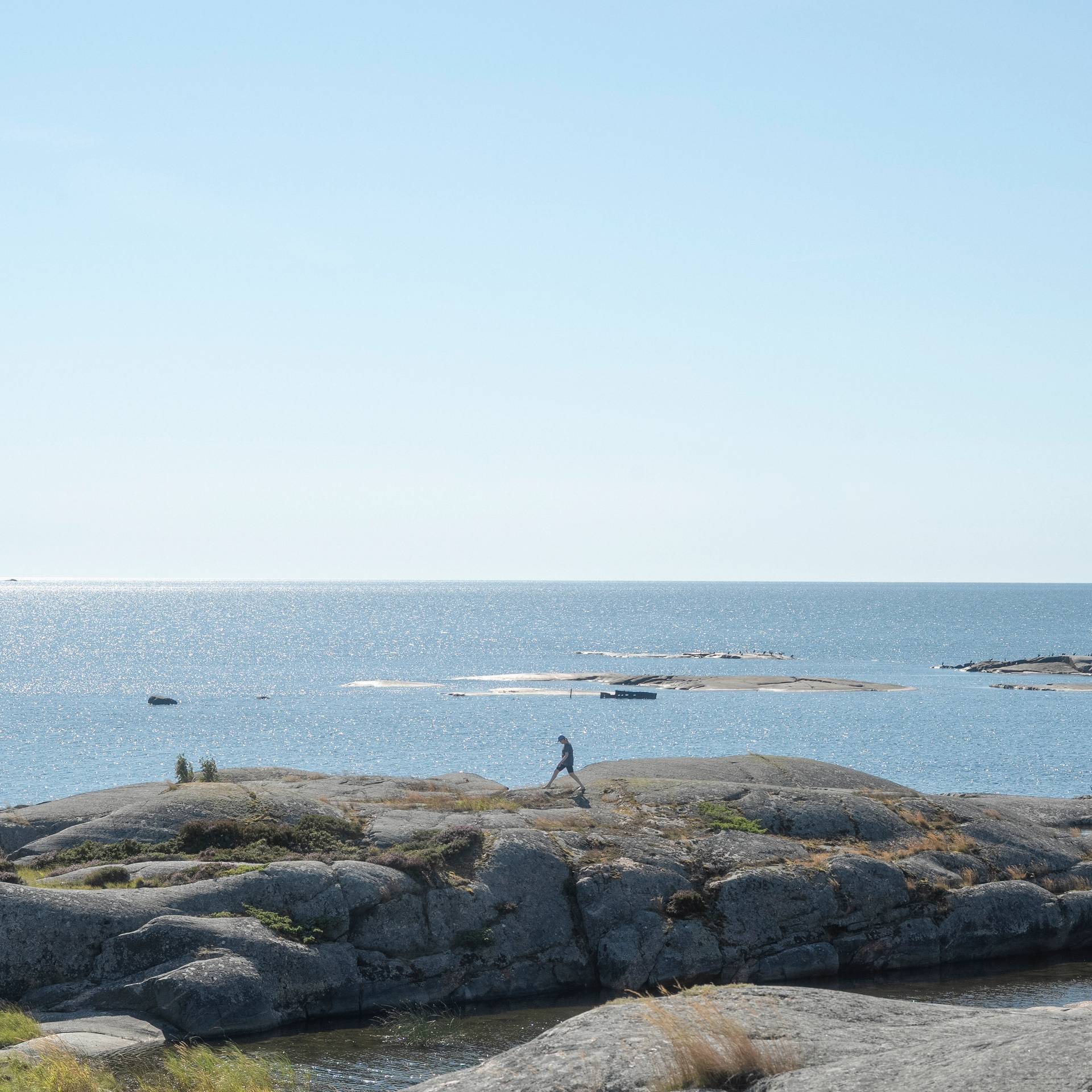 A person walking along the archipelago coast.