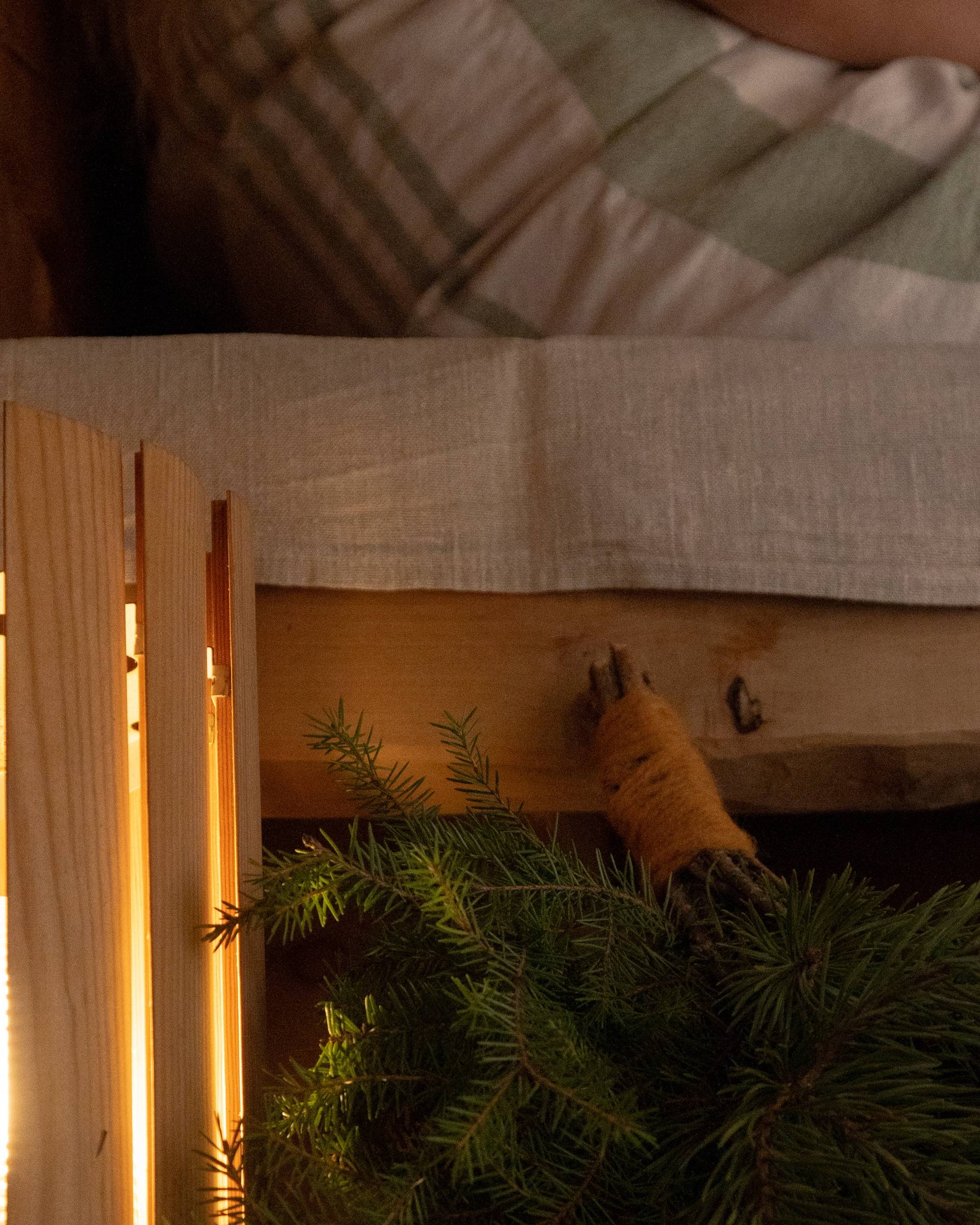 A whisk laying on the sauna steps.