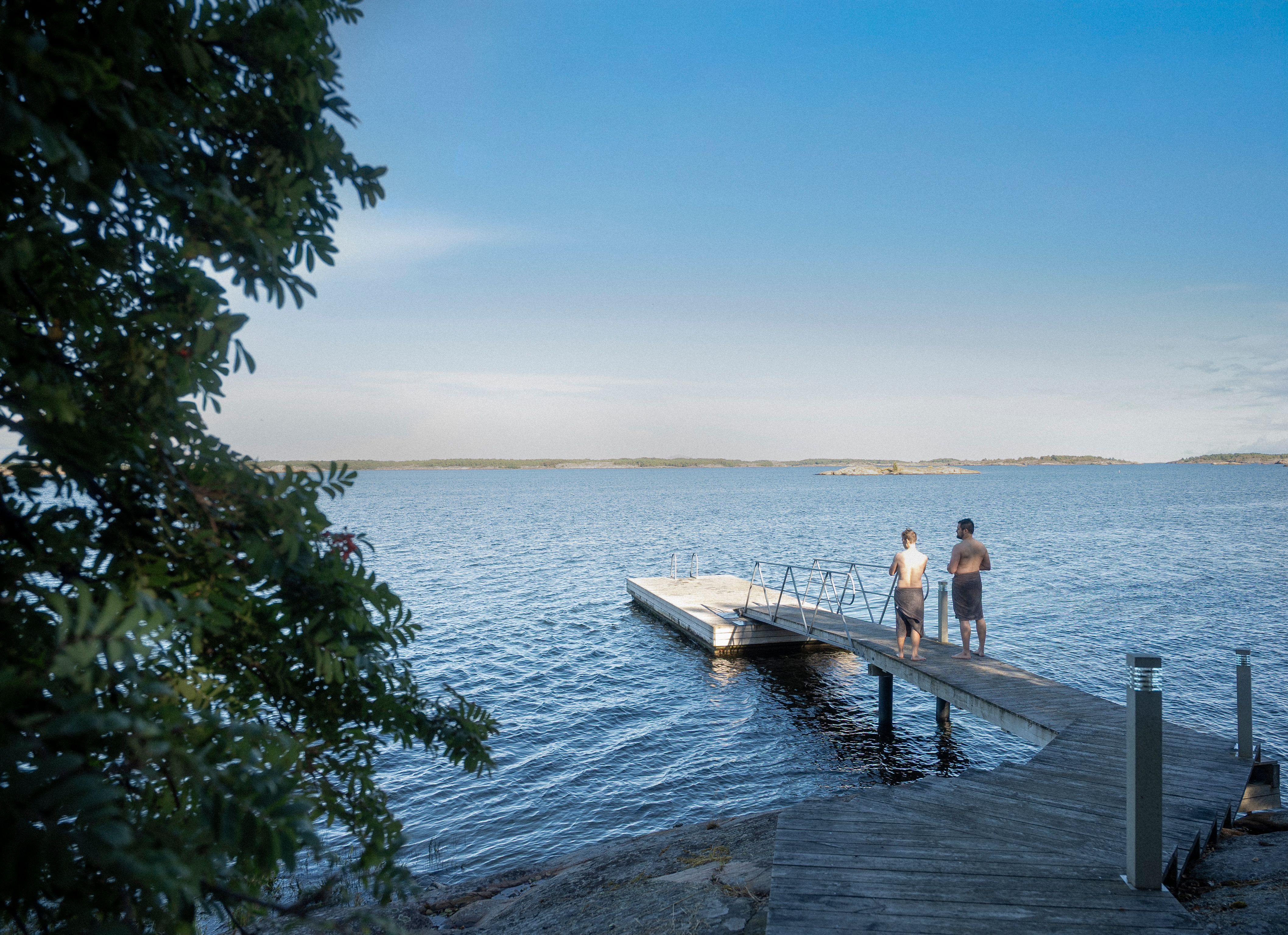 Two people standing on a dock.