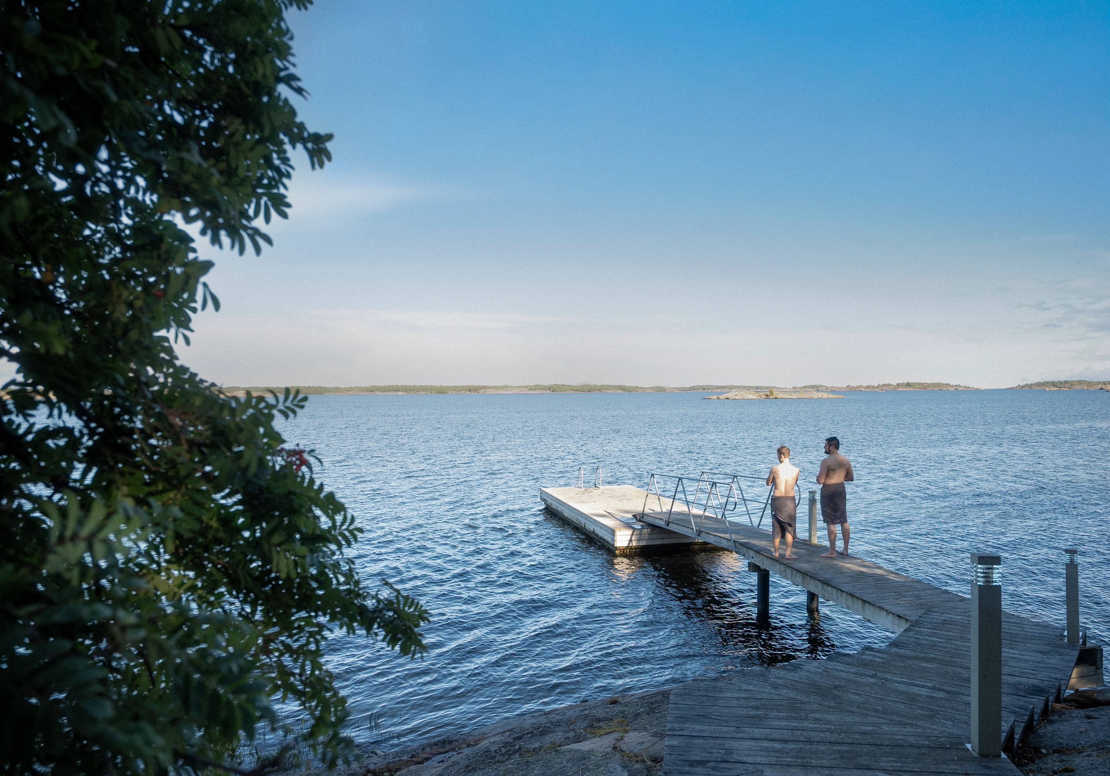 Two people standing on a dock.