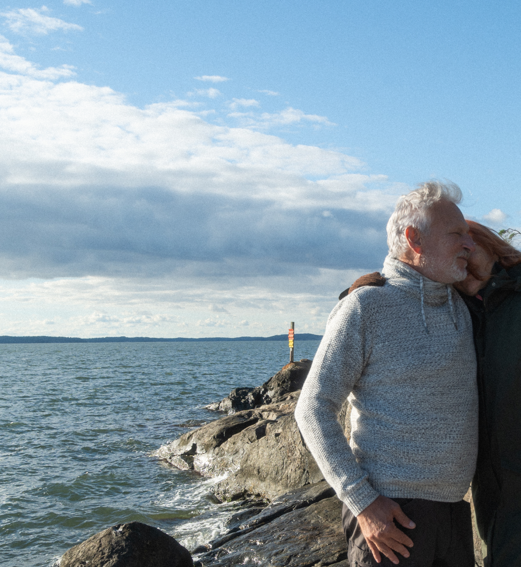 A couple hugging on an island by the Finnish archipelago sea