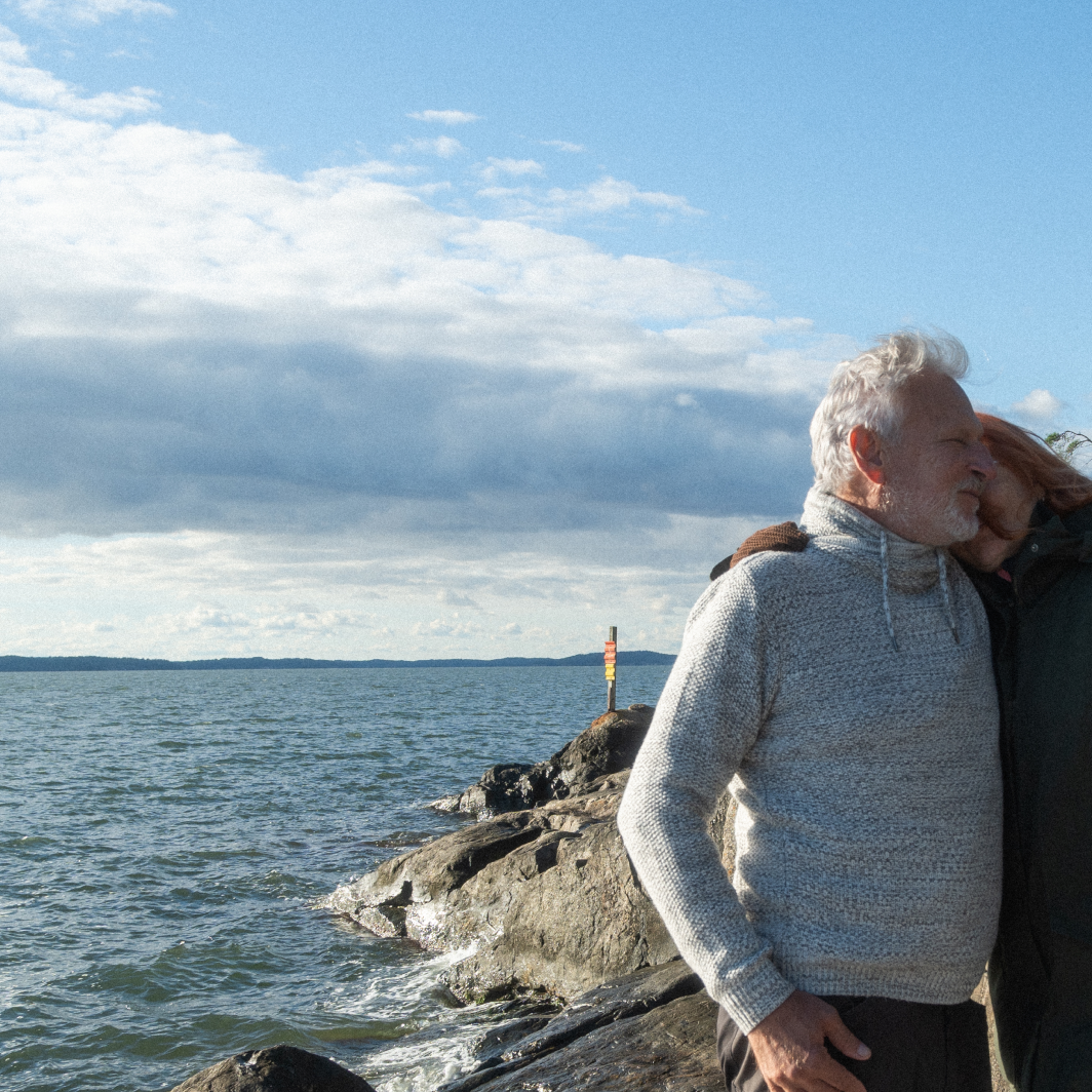 A couple hugging on an island by the Finnish archipelago sea