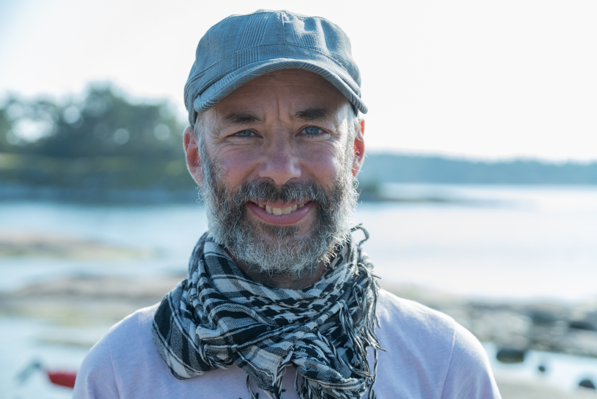 A picture of a happy kayaking instructor in finnish archipelago