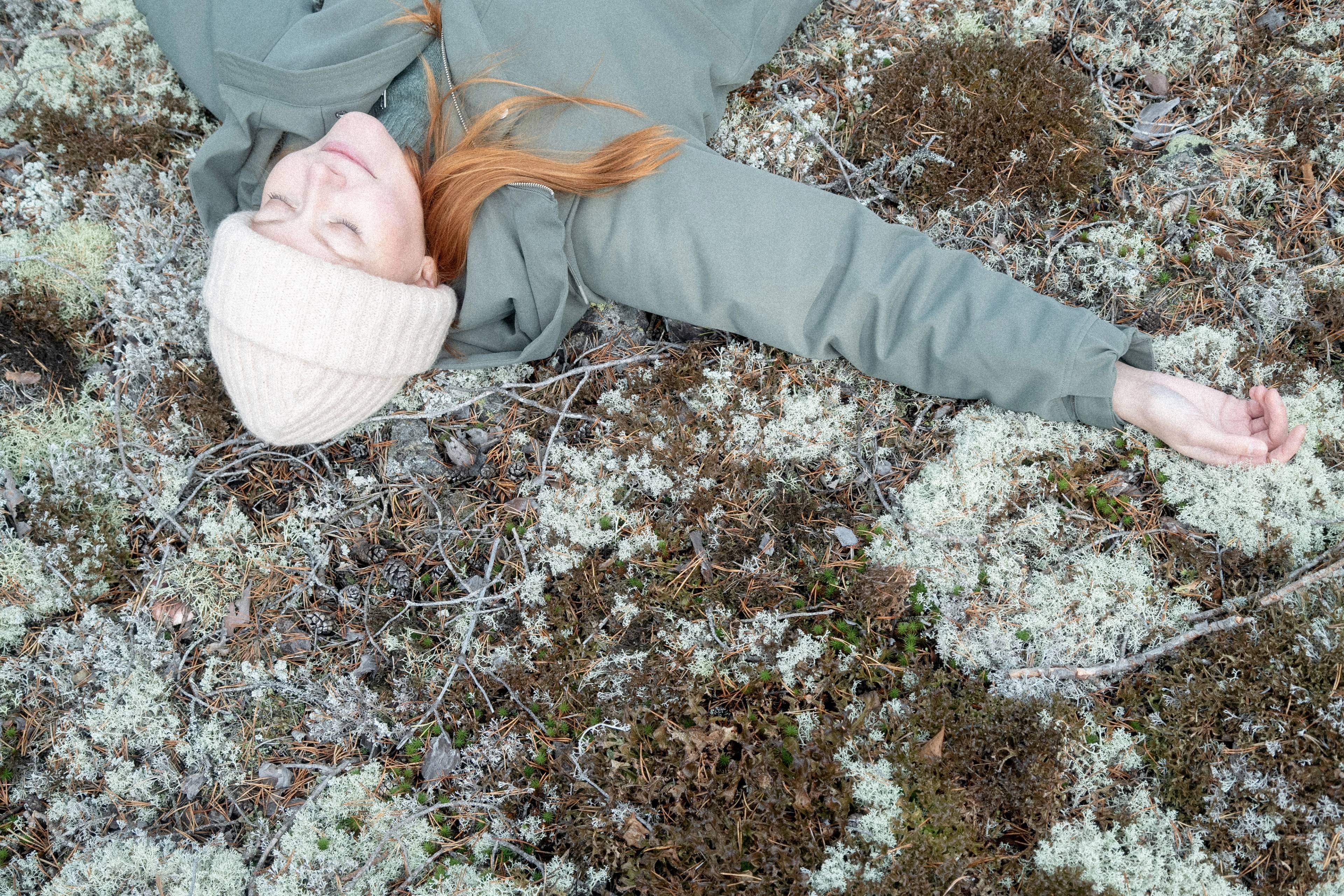 A woman laying in the forest.