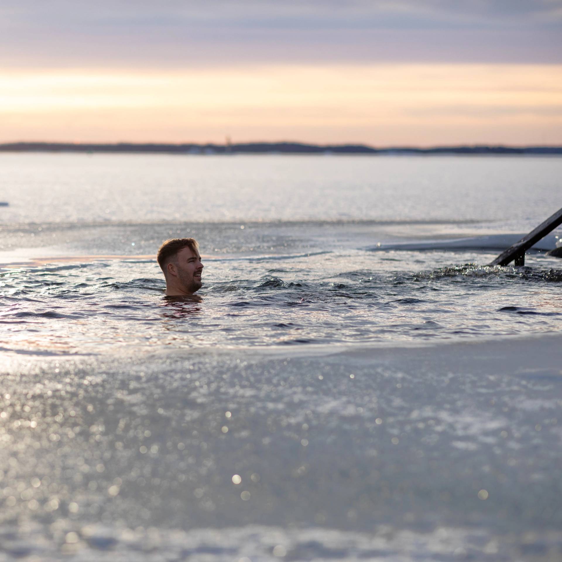 A man ice-swimming with only his head above the water.