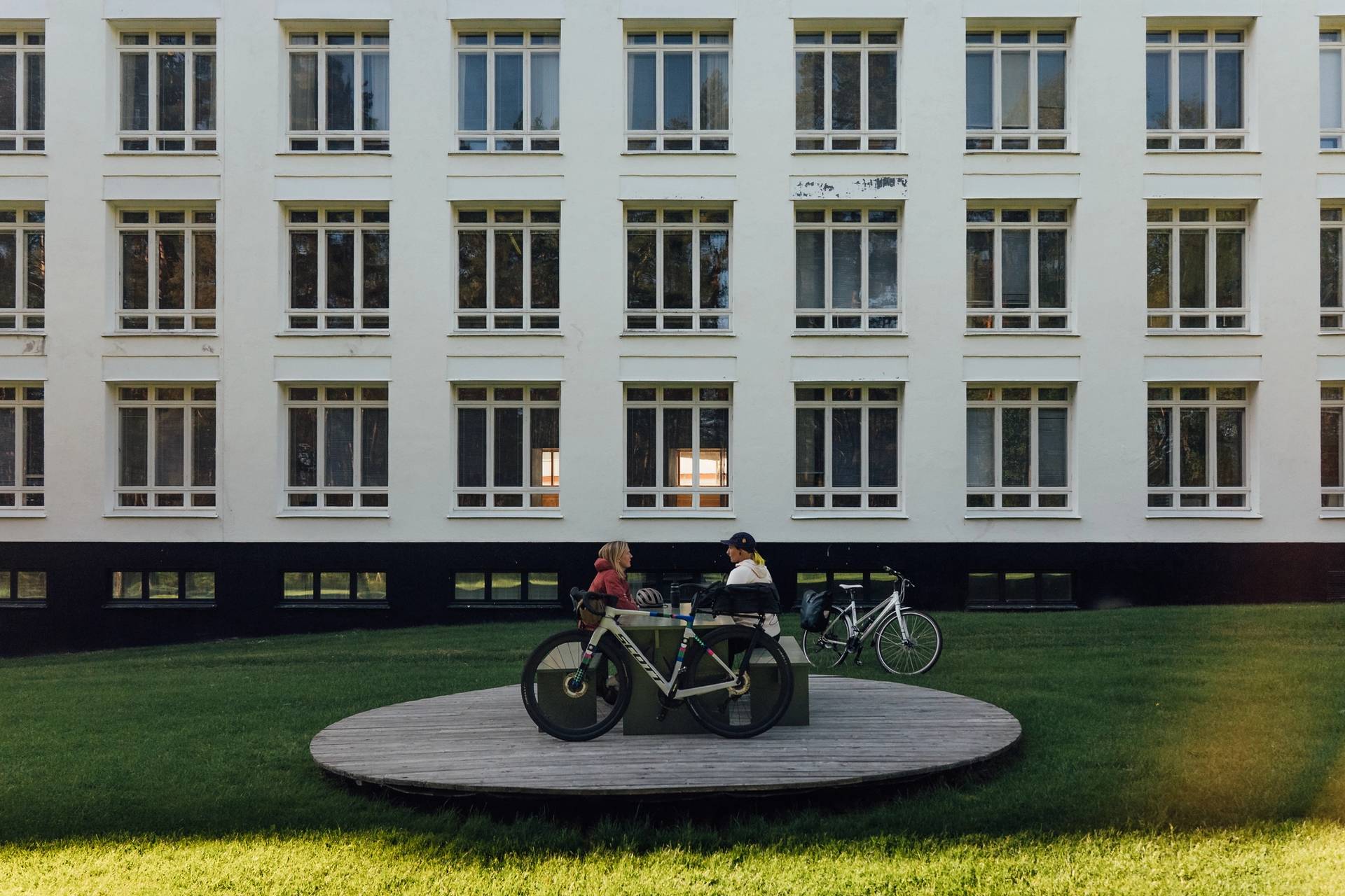 Friends on an island bicycle tour taking a break in Paimio Sanatorium