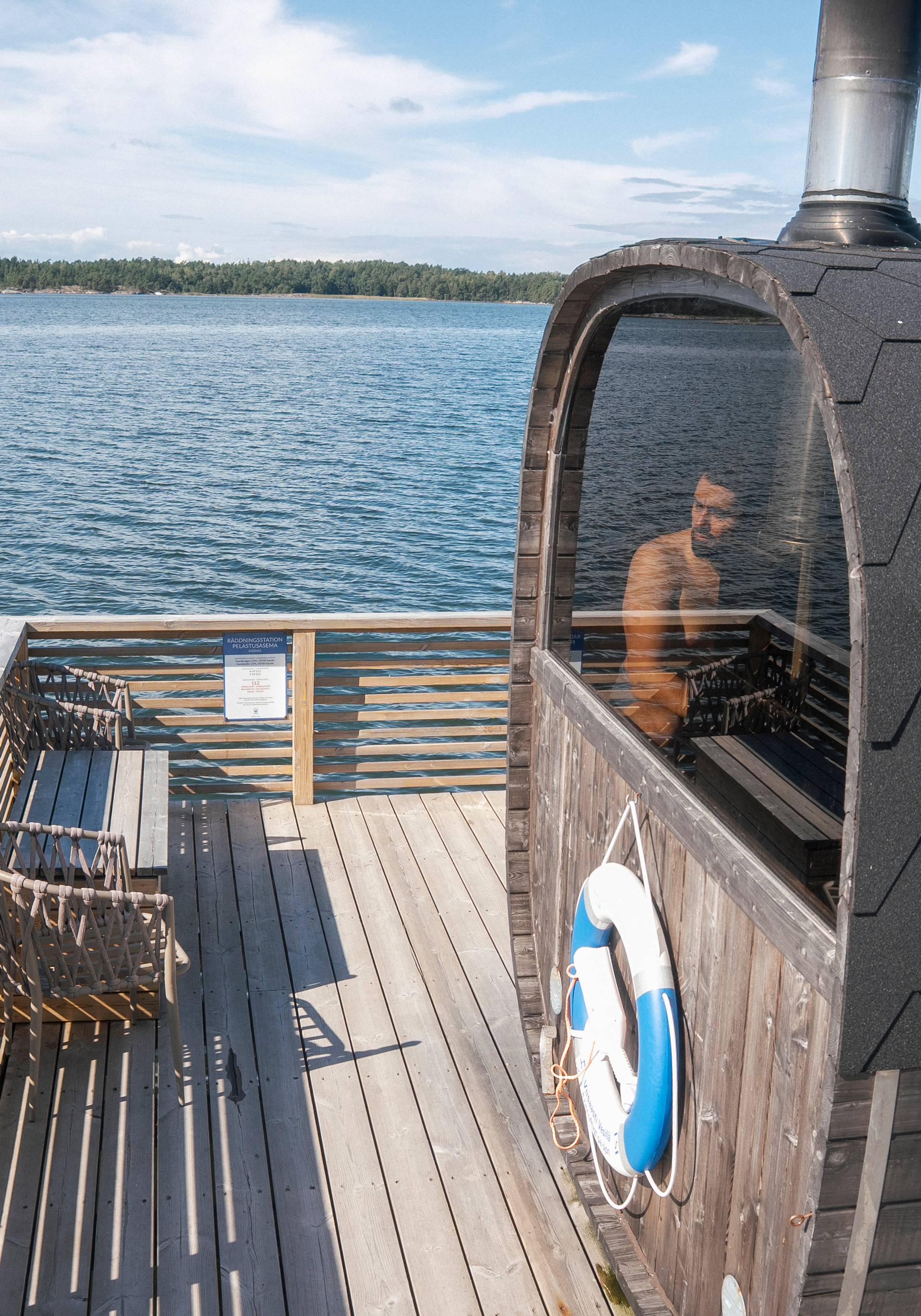 A man enjoying a sauna on the dock.