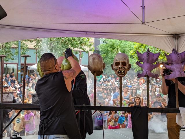 Crowds wait in horror as Distortions Unlimited creates monster masks before their very eyes