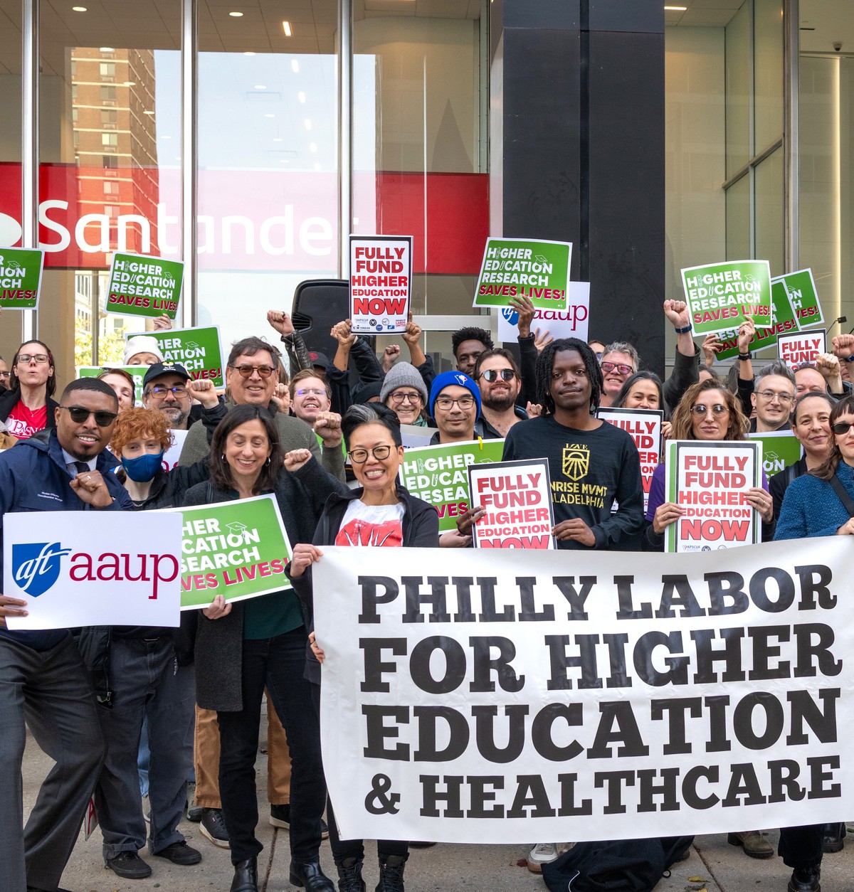 Striking workers hold a banner that reads "Philly Labor for Higher Education and Healthcare"