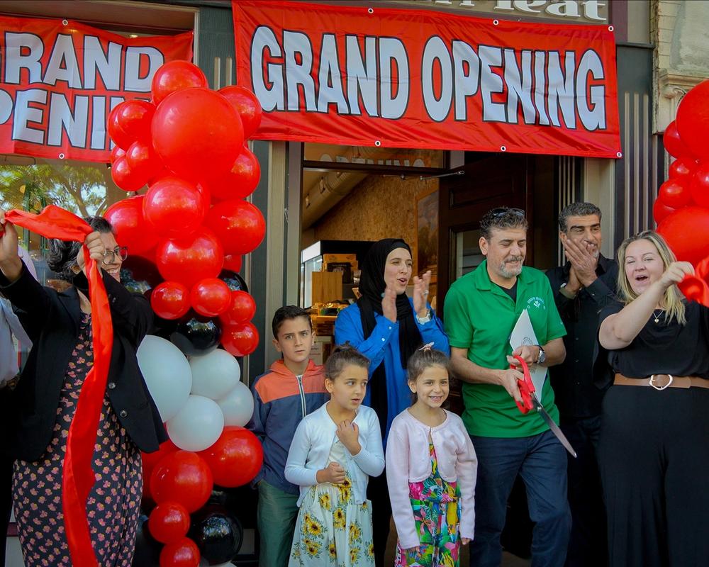 Hebron Market halal butcher Boston grand opening celebration with red balloons and community
