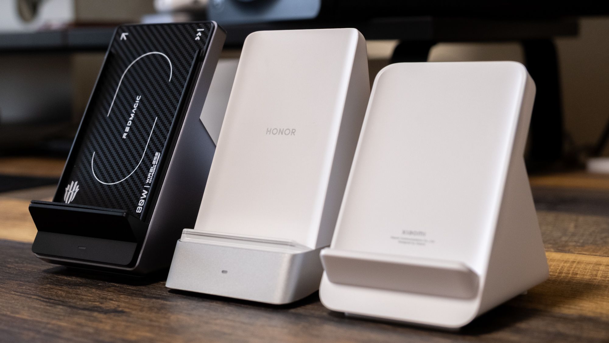 Three wireless charging stands on a desk