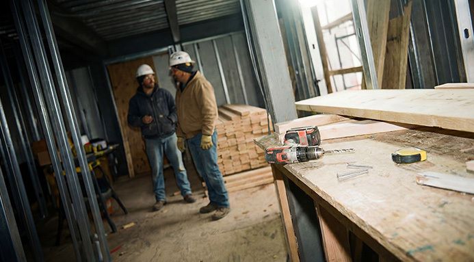 Two construction workers on a job site